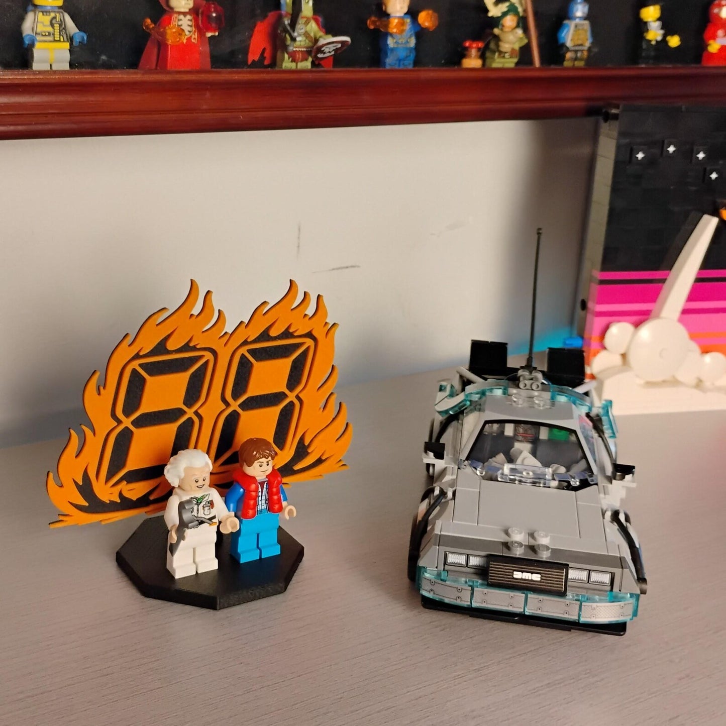 Back to the Future minifigure display shown on a desk with DeLorean time machine build and collector shelf in the background.