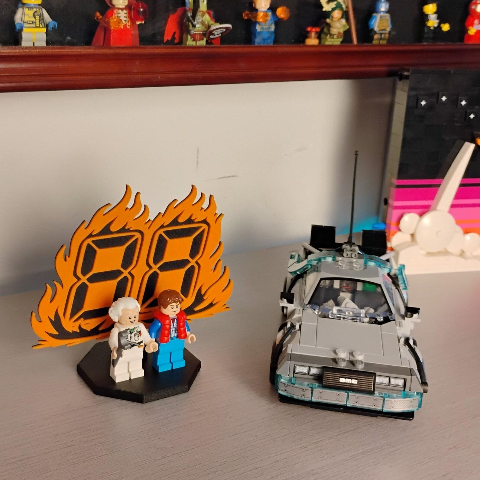 Back to the Future minifigure display shown on a desk with DeLorean time machine build and collector shelf in the background.