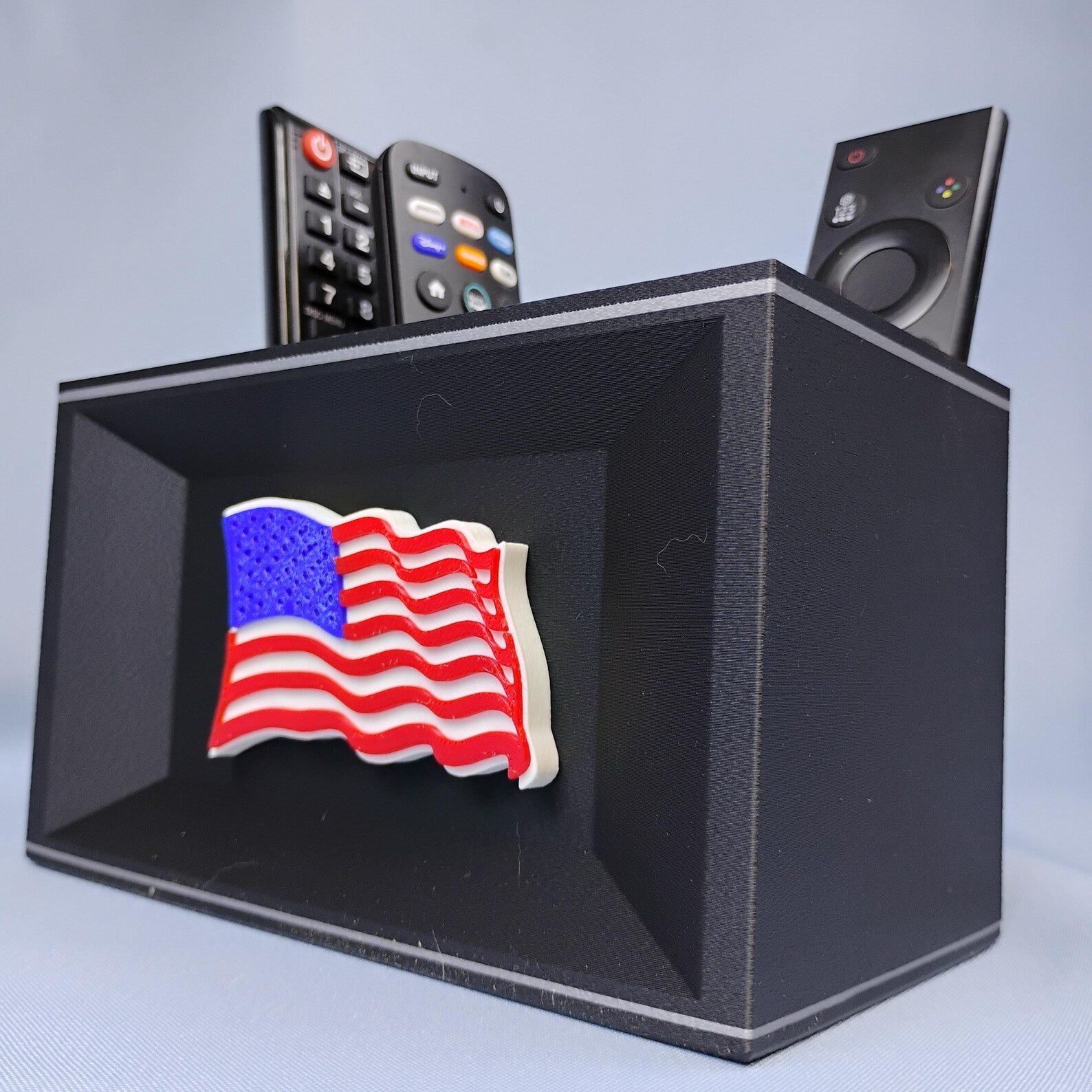 Black American flag desk organizer with raised patriotic flag detail and remote storage compartments