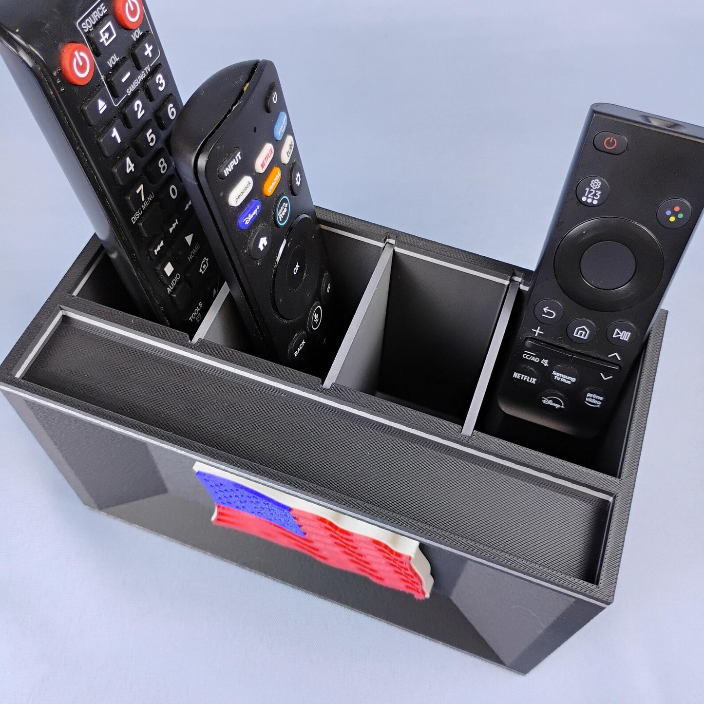 Black American flag remote control holder with separate compartments for TV remotes