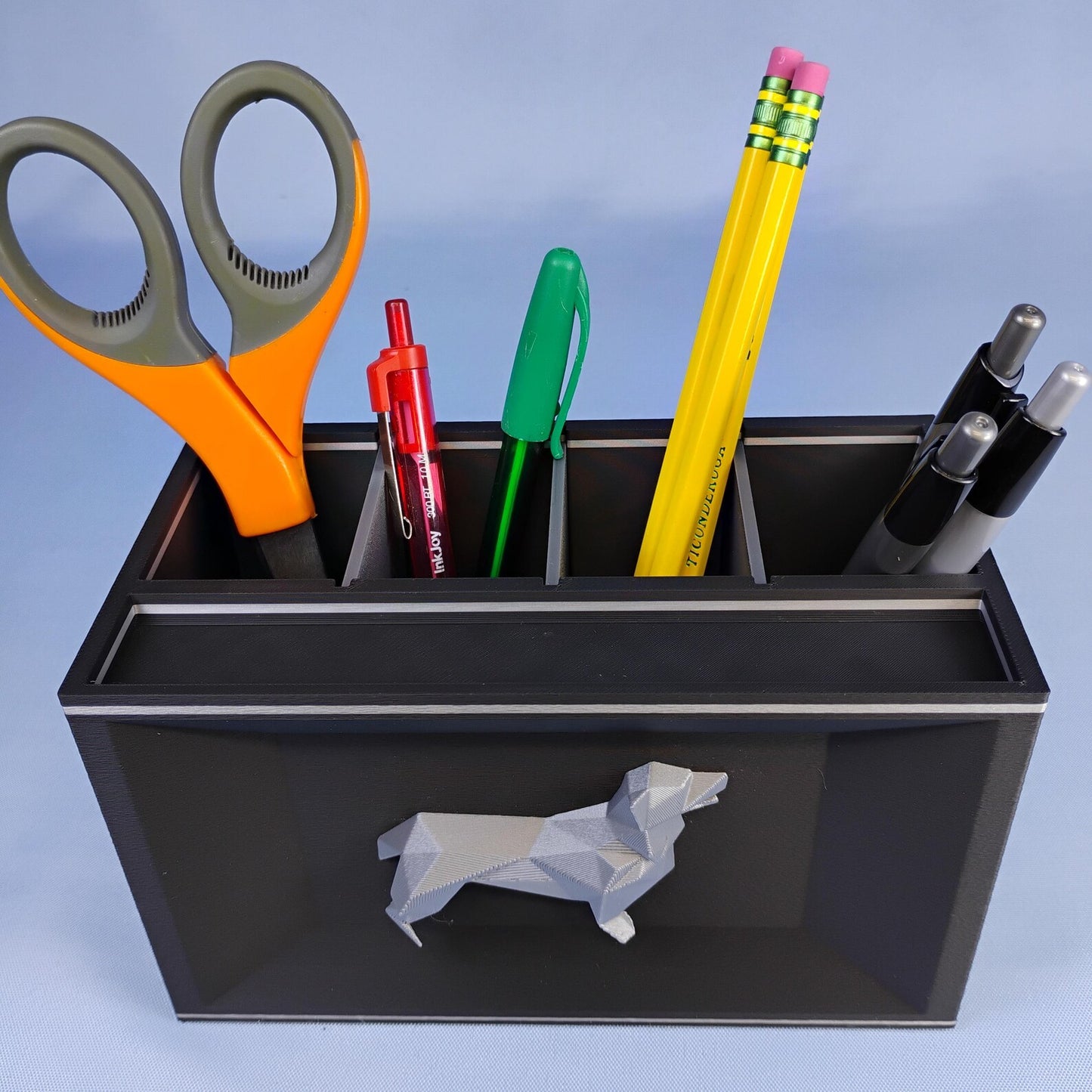 Black Corgi desk caddy with removable dividers holding pens, pencils, and scissors