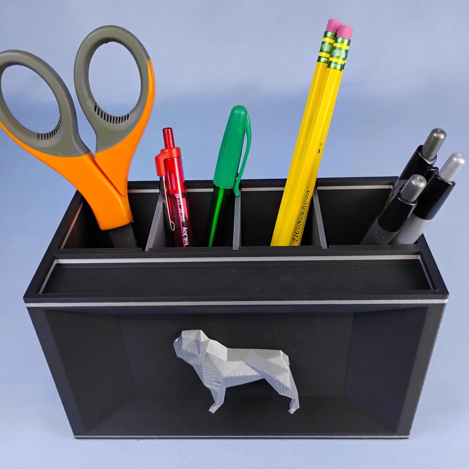 Black French Bulldog desk caddy with removable dividers holding pens, pencils, and scissors