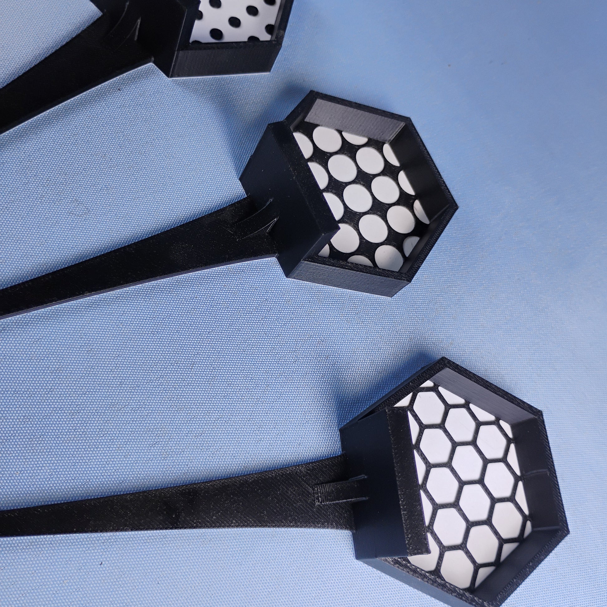 Black LEGO® minifigure plant stake displays showing multiple geometric background designs and attached minifigure plates.