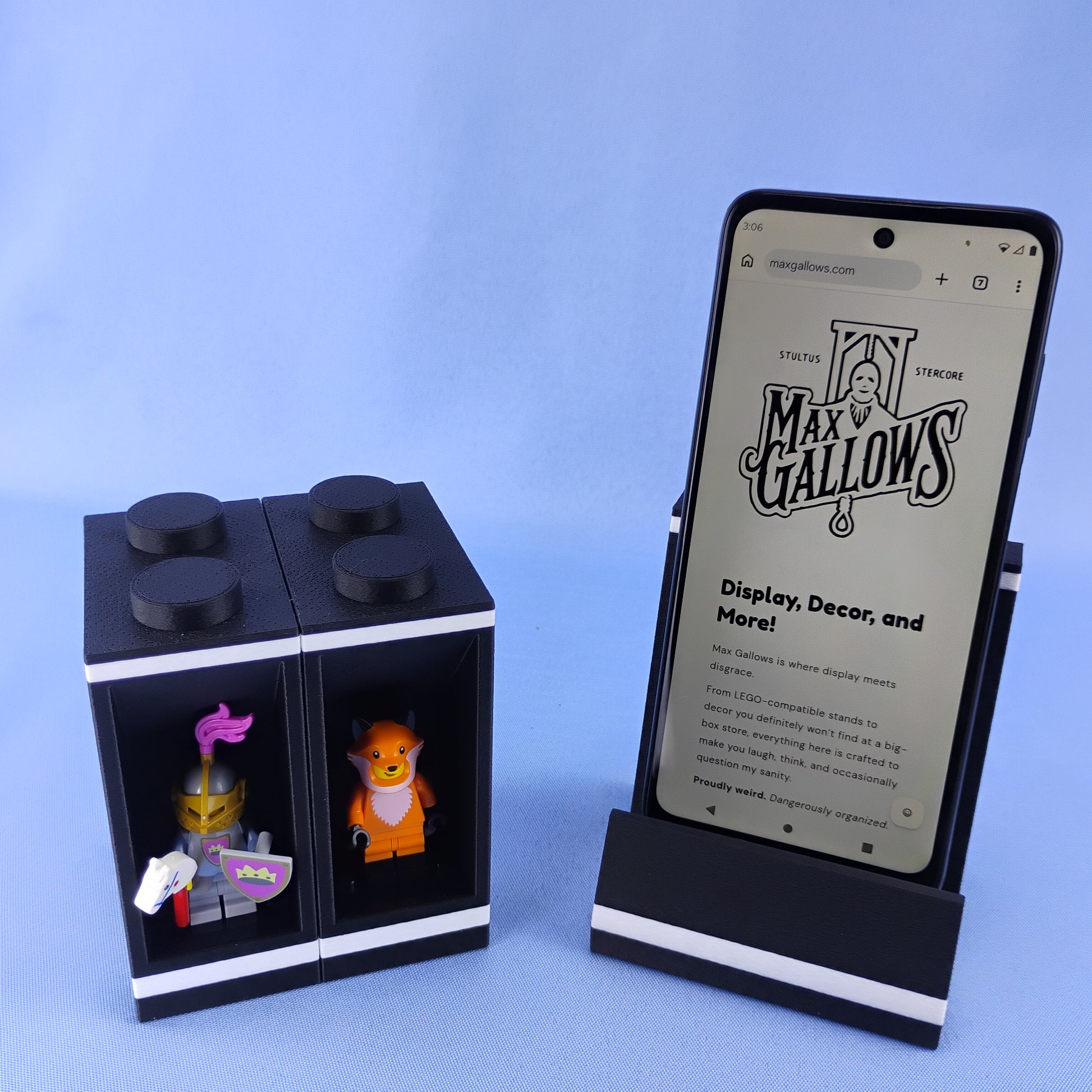 Black two-level LEGO® minifigure display module shown beside the matching modular smartphone stand.