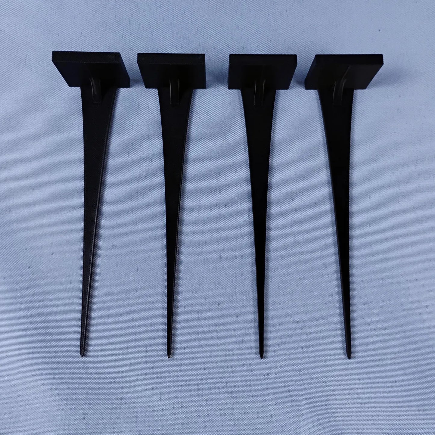 Set of four black plant pot stakes for displaying LEGO® minifigures
