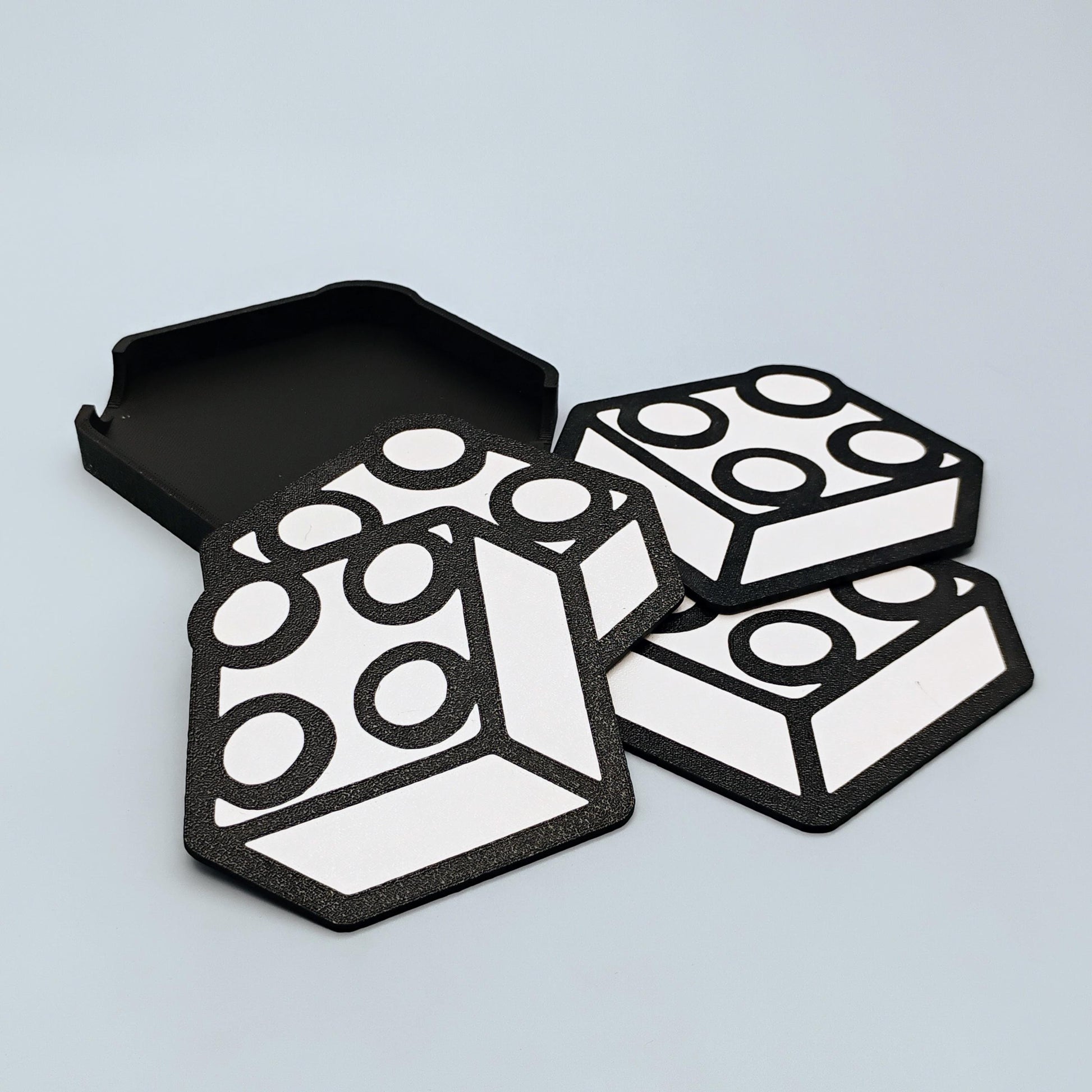 Black and white brick-inspired coaster set with matching holder