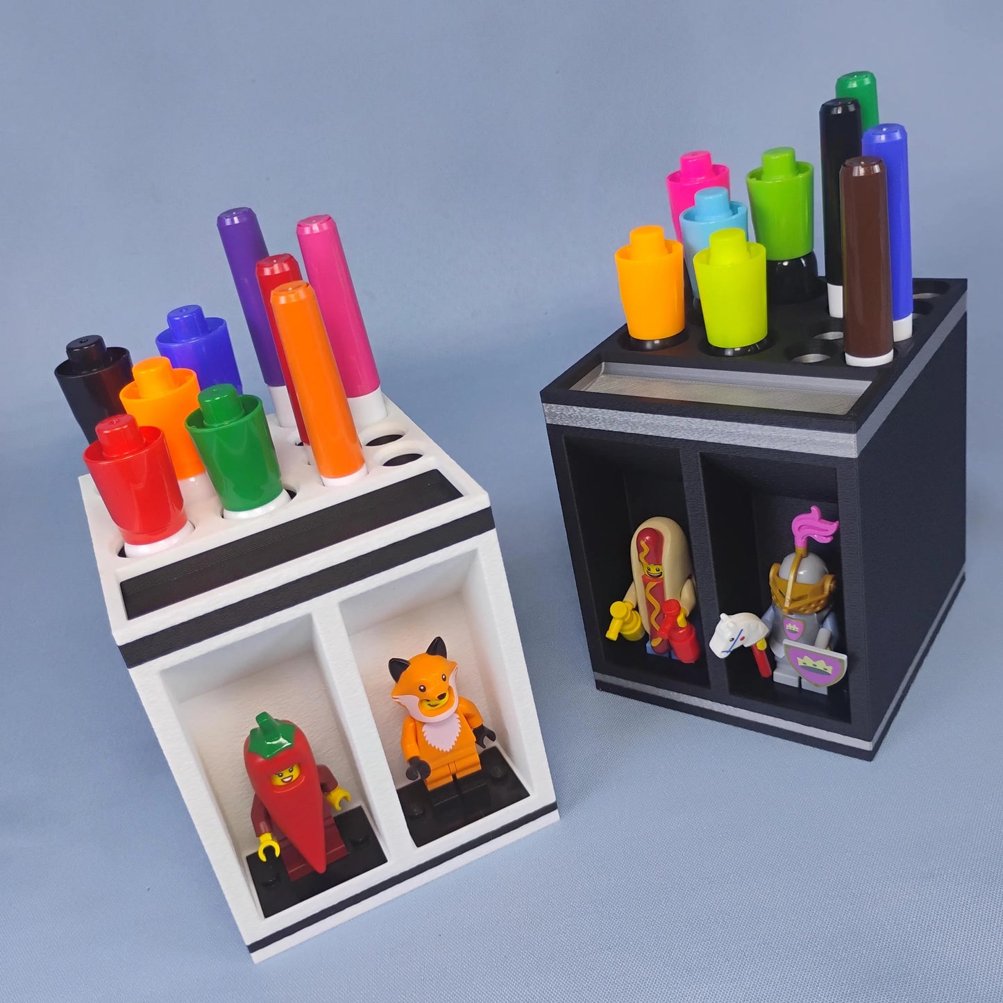 Angled view of white and black dry erase marker holders filled with colorful markers and LEGO® minifigures in the two front display compartments.