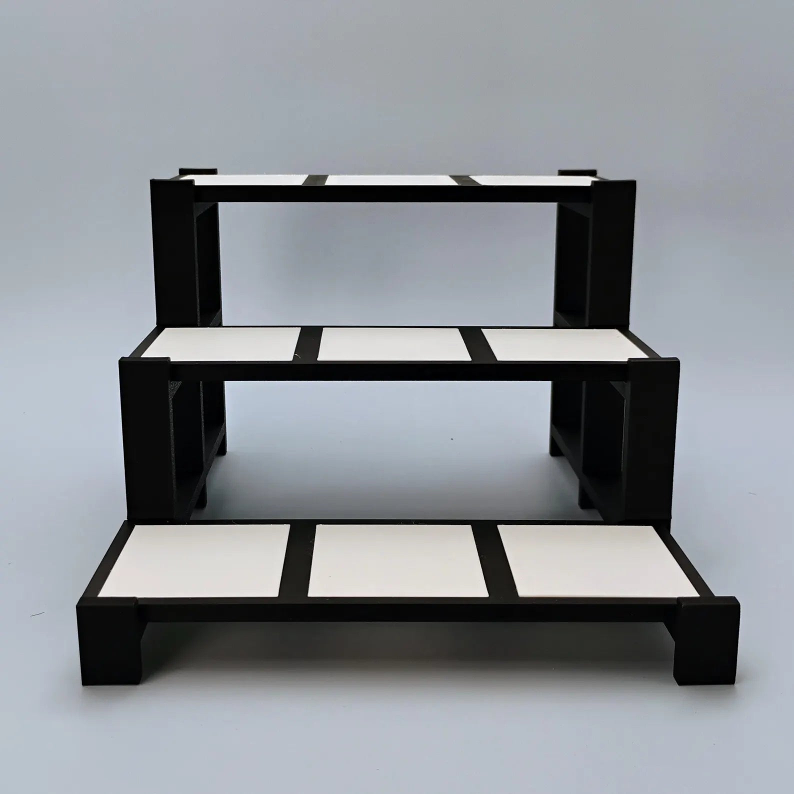 Empty black and white tiered display stand for Funko Pops, collectibles, trinkets, and shelf decor.