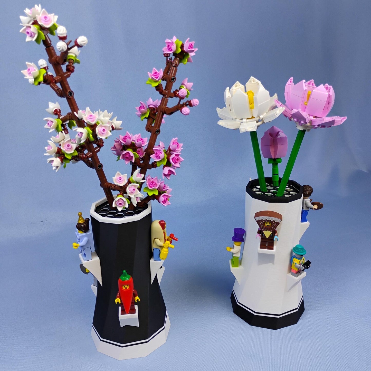 Black and white vases displaying LEGO® botanical flowers with minifigure shelves around the sides