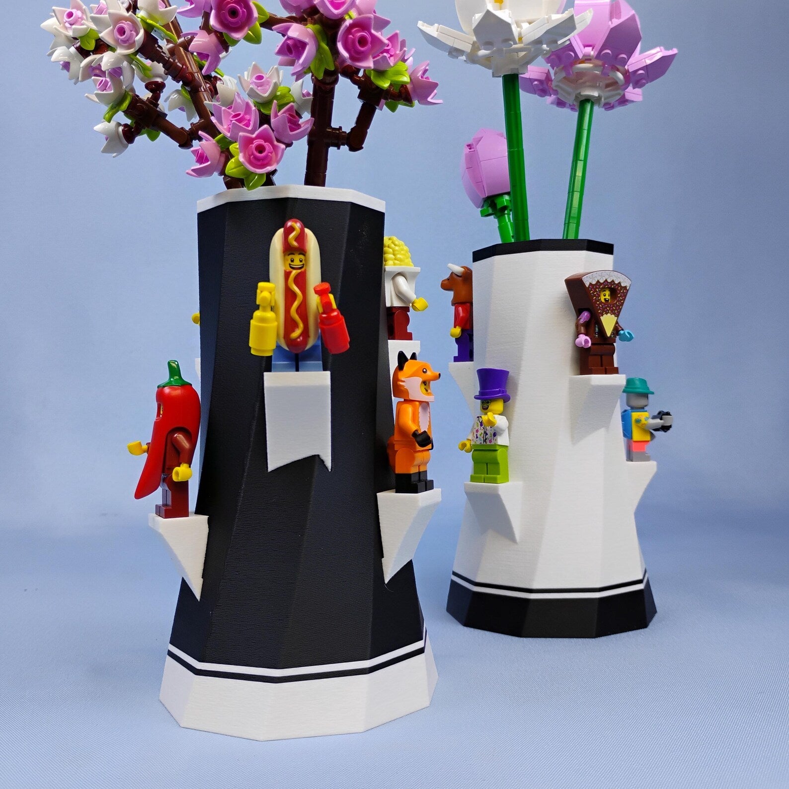 Black and white LEGO® botanical vases with built-in shelves for displaying minifigures