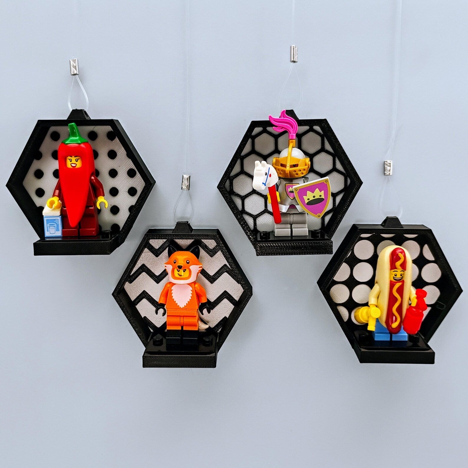 Black window-hanging minifigure displays with suction cup lines, patterned backgrounds, and LEGO® minifigures shown on 3x4 plates.