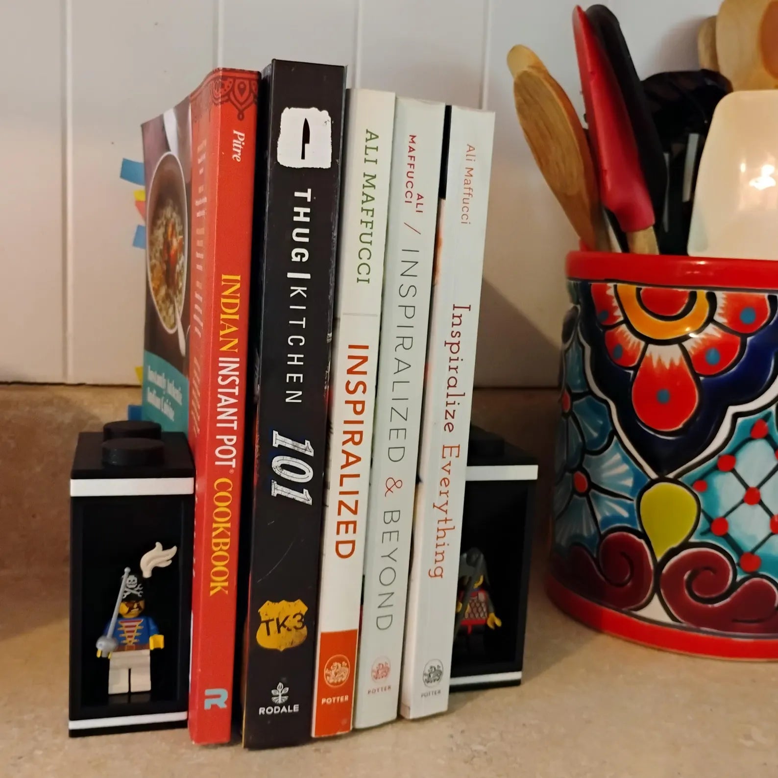 White bookends holding books upright with a LEGO® minifigure display built into the side