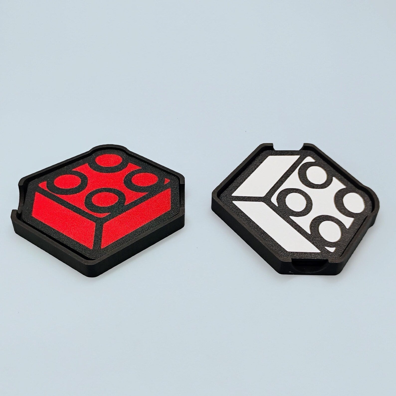 Red and black and white brick-inspired coaster options shown side by side