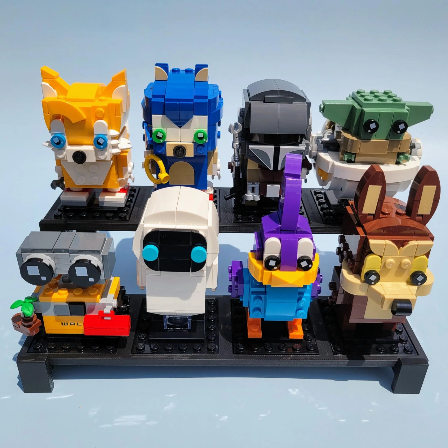 Display stand for LEGO BrickHeadz figures. Four figures wide by two figures deep.