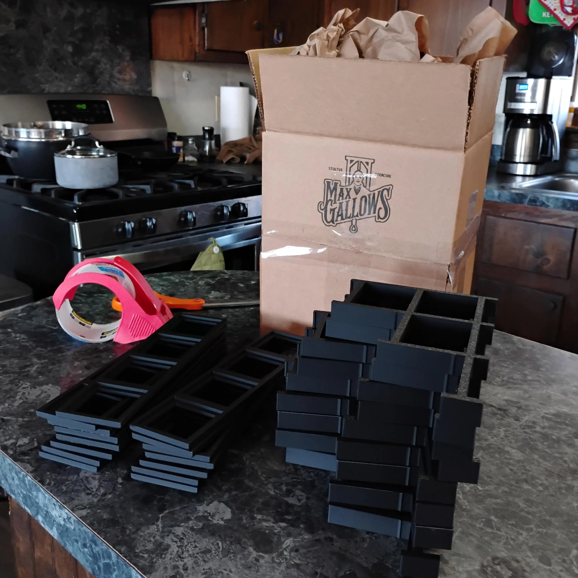 A pile of Brickheadz Display stands being boxed up to ship
