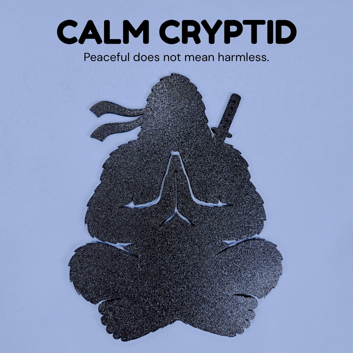 Calm Cryptid Ninja Bigfoot silhouette sitting in a cross-legged meditation pose with a sword on its back.