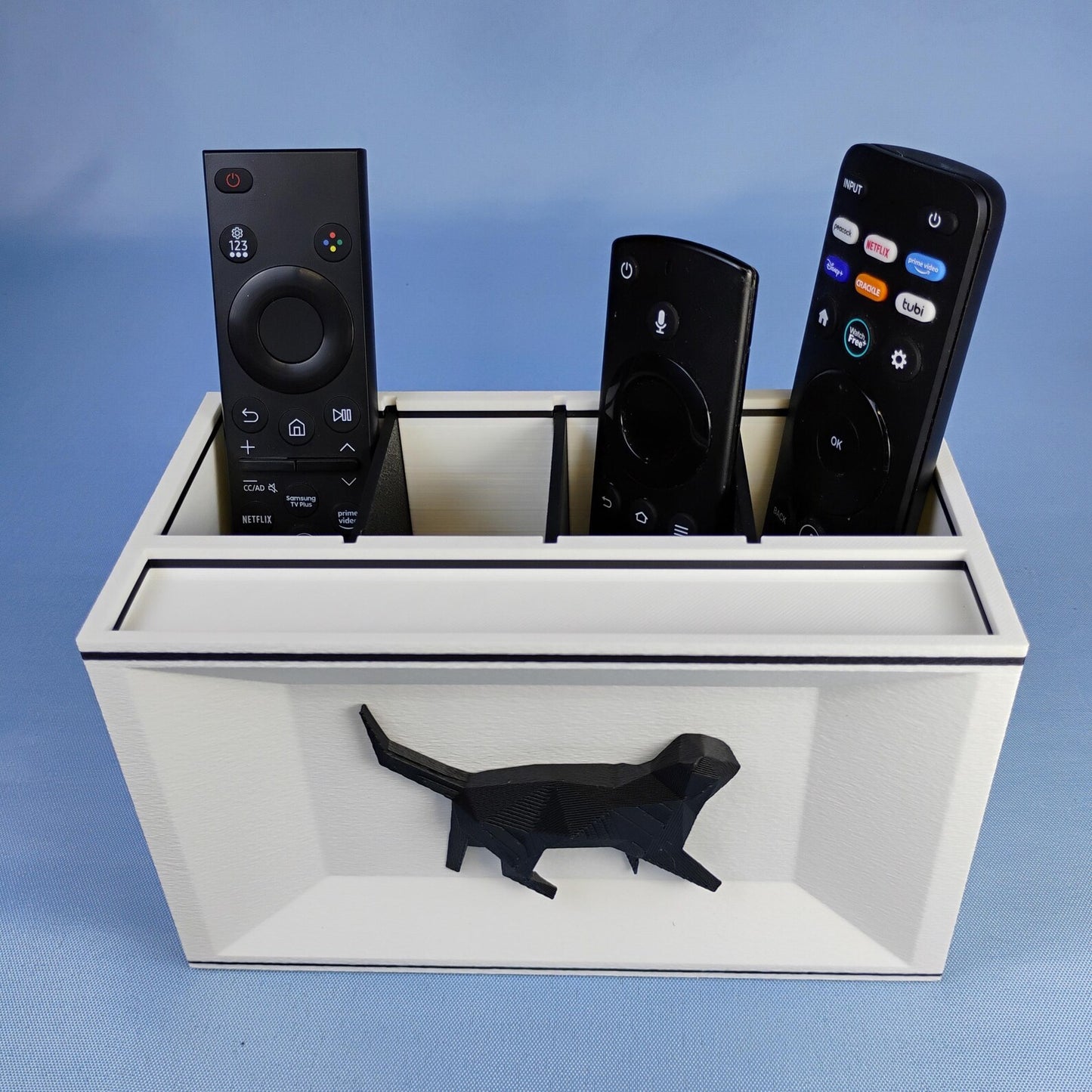 White Cat desk organizer holding TV remotes with raised black cat detail on the front