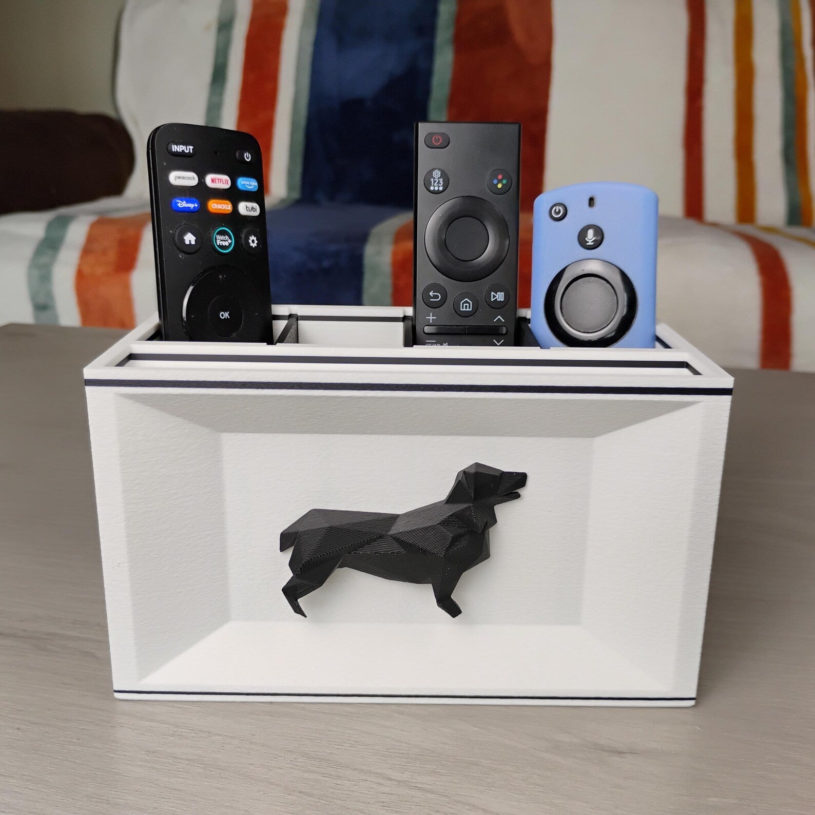 White Corgi desk organizer on a tabletop holding remotes and small electronics