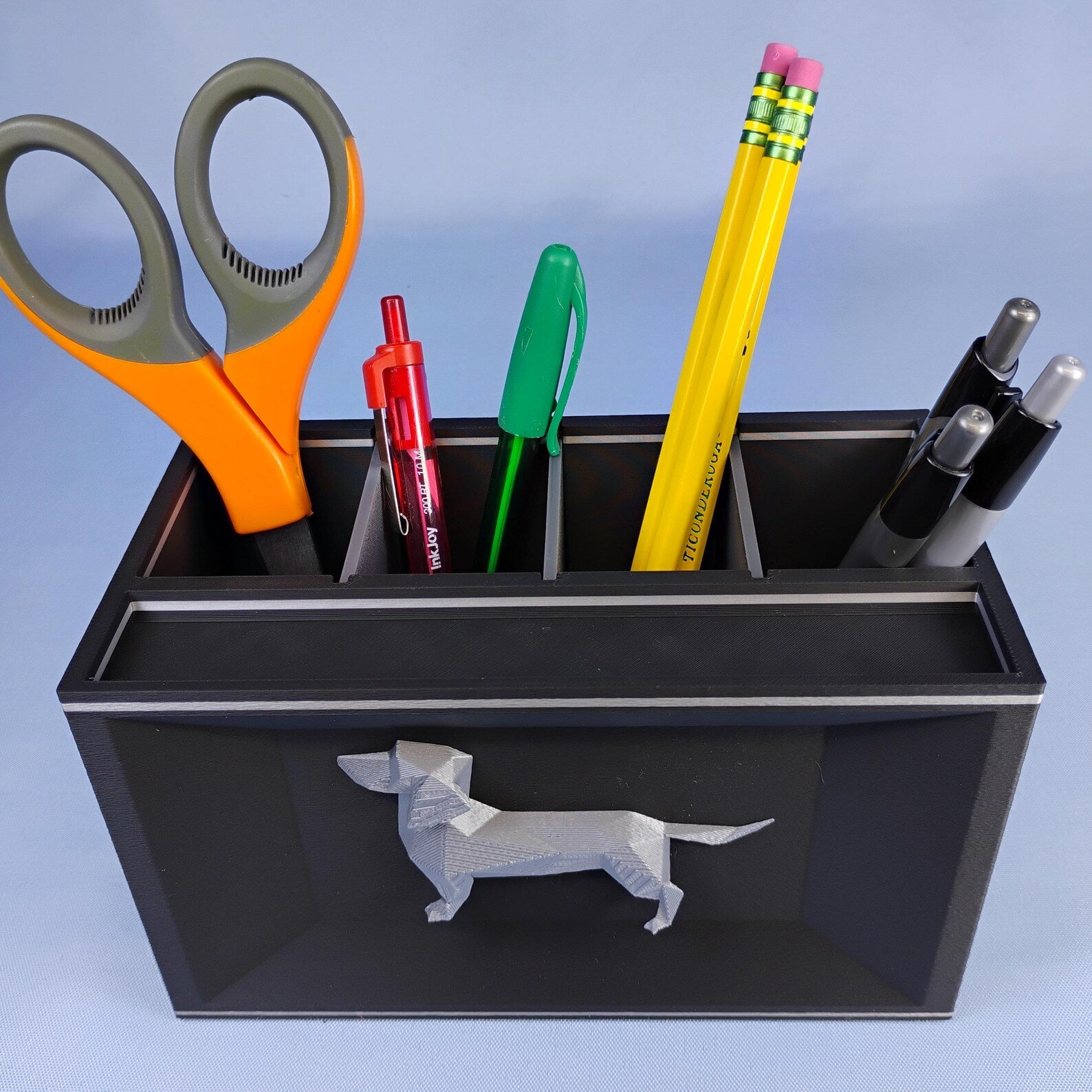 Black Dachshund desk organizer used as a pencil cup with scissors, pens, pencils, and markers