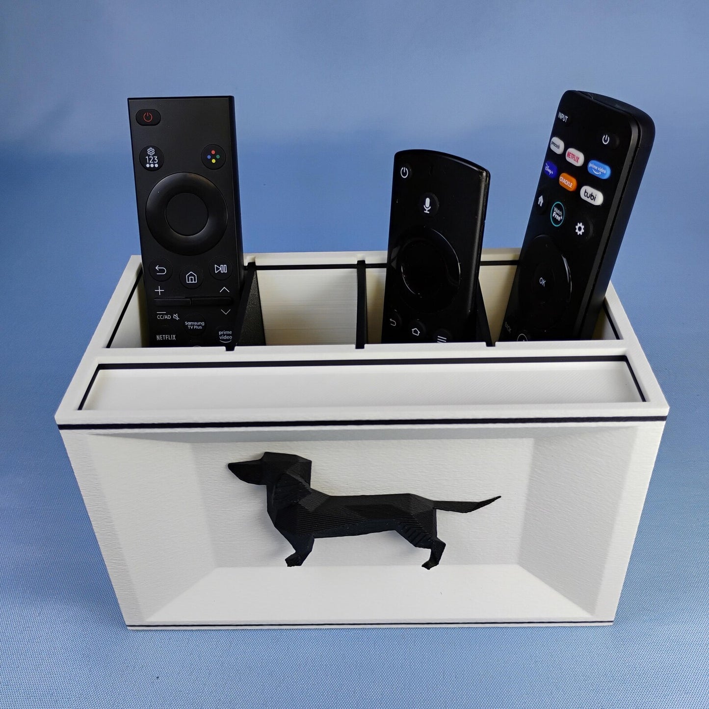 White Dachshund remote control holder with removable dividers and black dog detail on the front