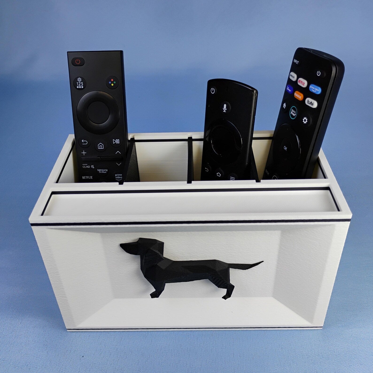 White Dachshund remote control holder with removable dividers and black dog detail on the front