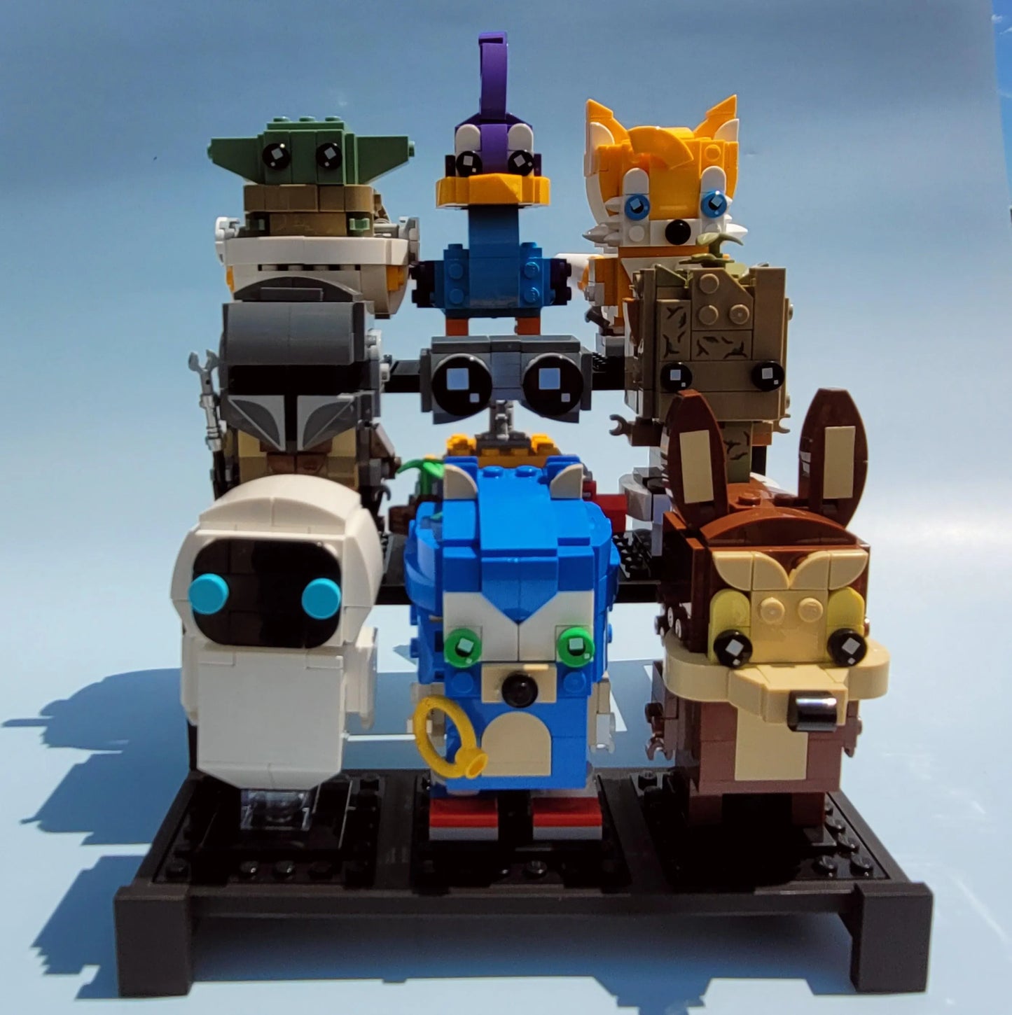 Display stand holding 8 LEGO Brickheadz sets on a blue background