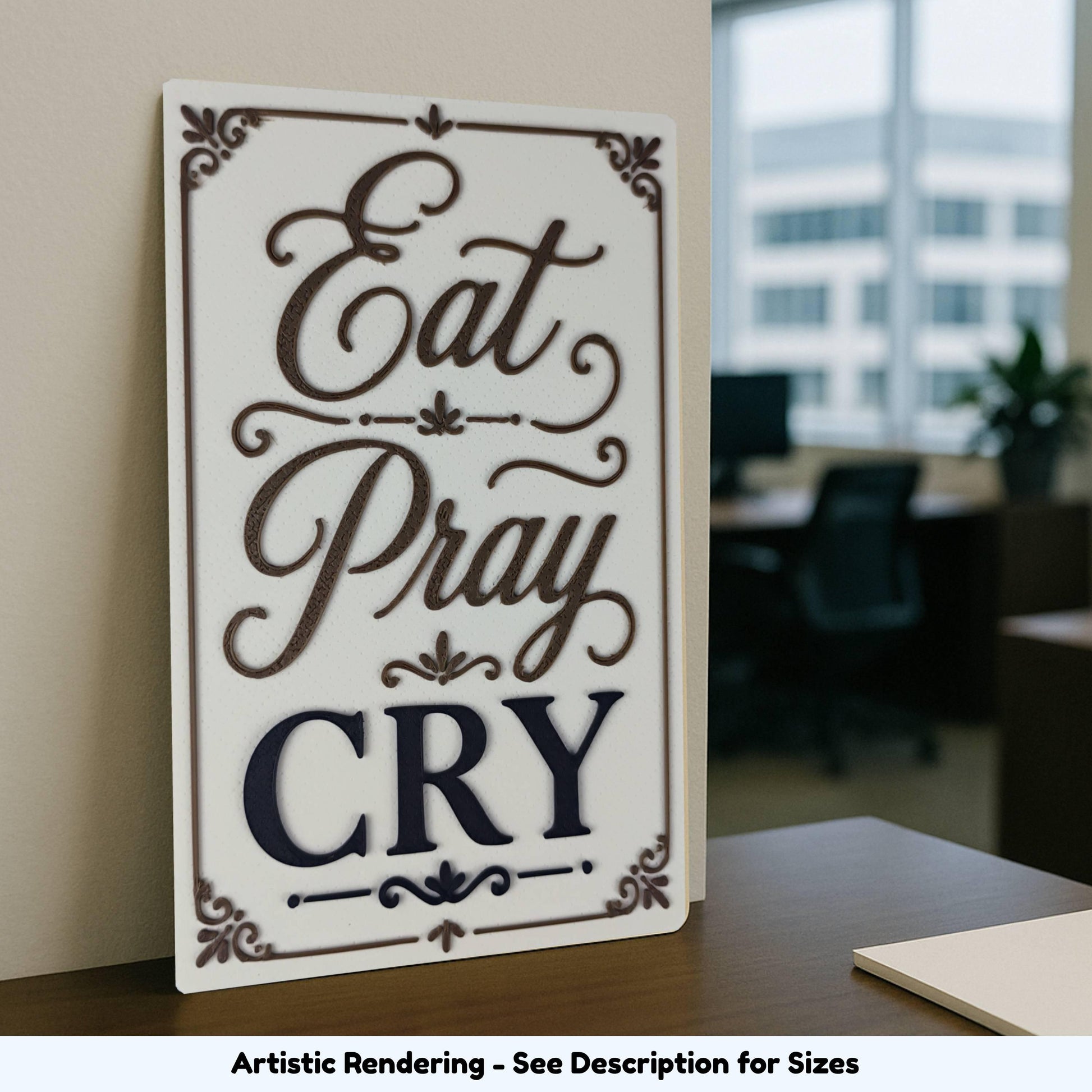 Eat Pray Cry sign displayed on an office desk near a window