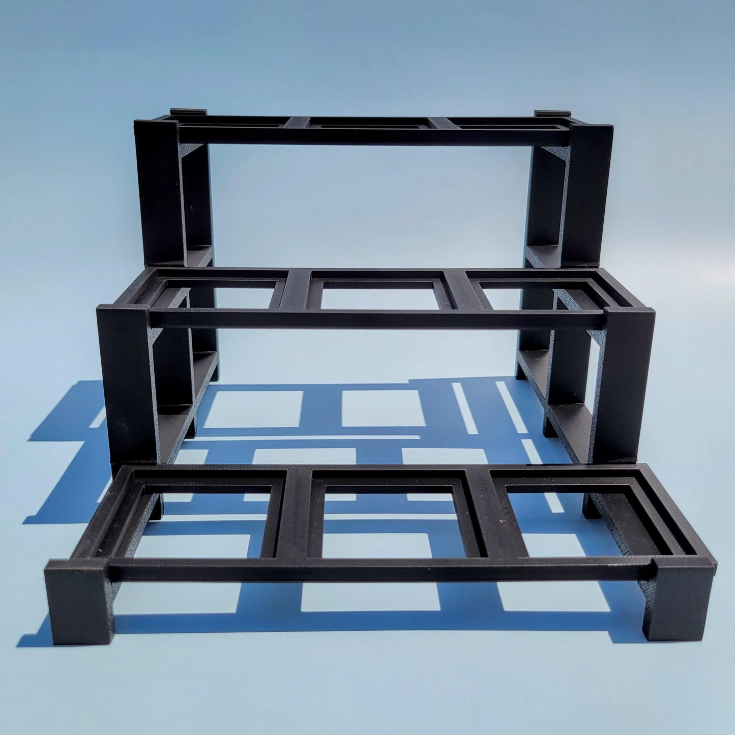 Empty display stand for LEGO Brickheads. 3 figures wide by three figures deep.