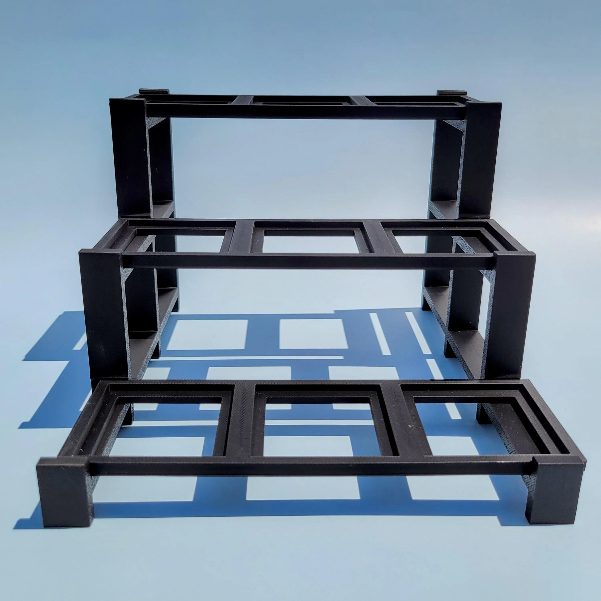 Empty display stand for LEGO Brickheads. 3 figures wide by three figures deep.