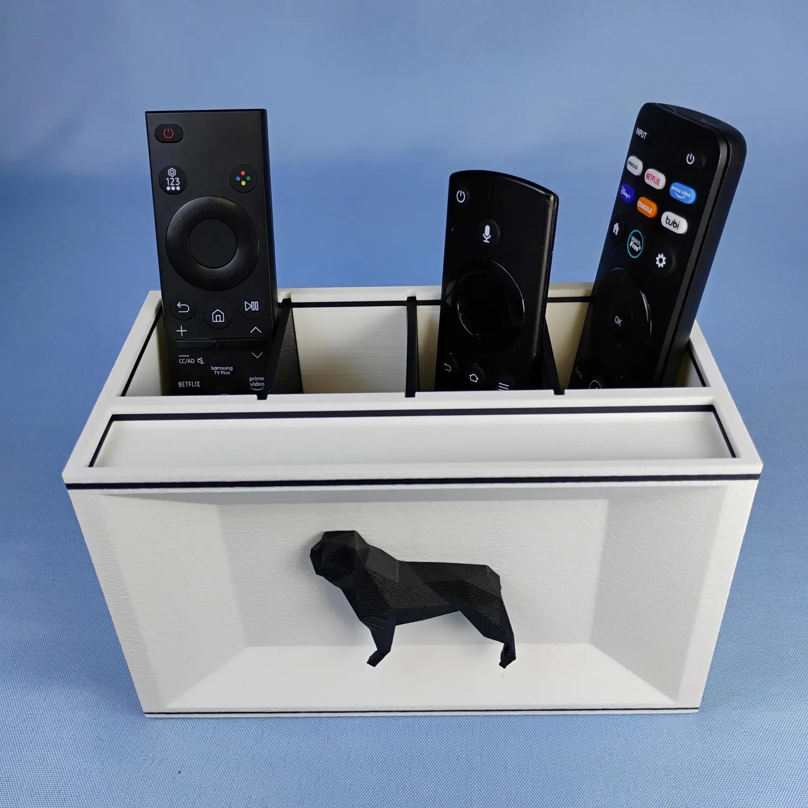 White French Bulldog desk organizer holding TV remotes with raised black dog detail on the front