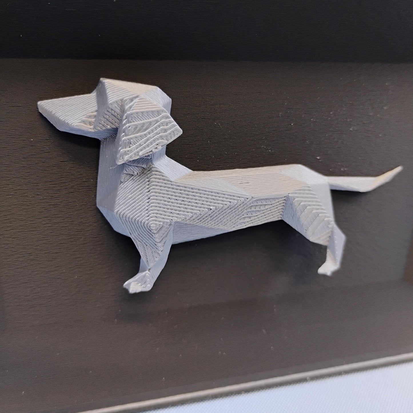 Close-up of raised geometric Dachshund detail used on the front of the desk organizer