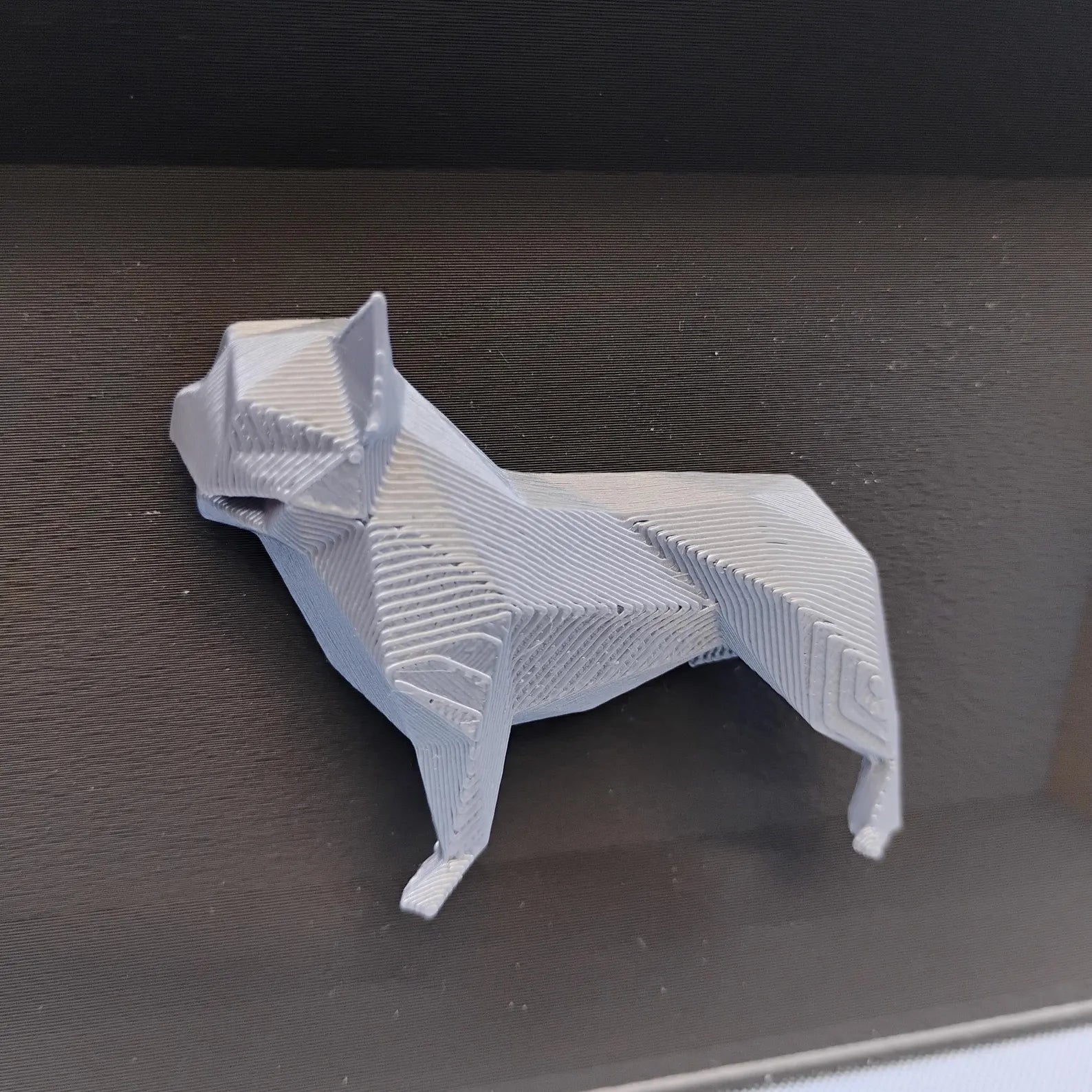 Close-up of raised geometric French Bulldog detail used on the front of the desk organizer