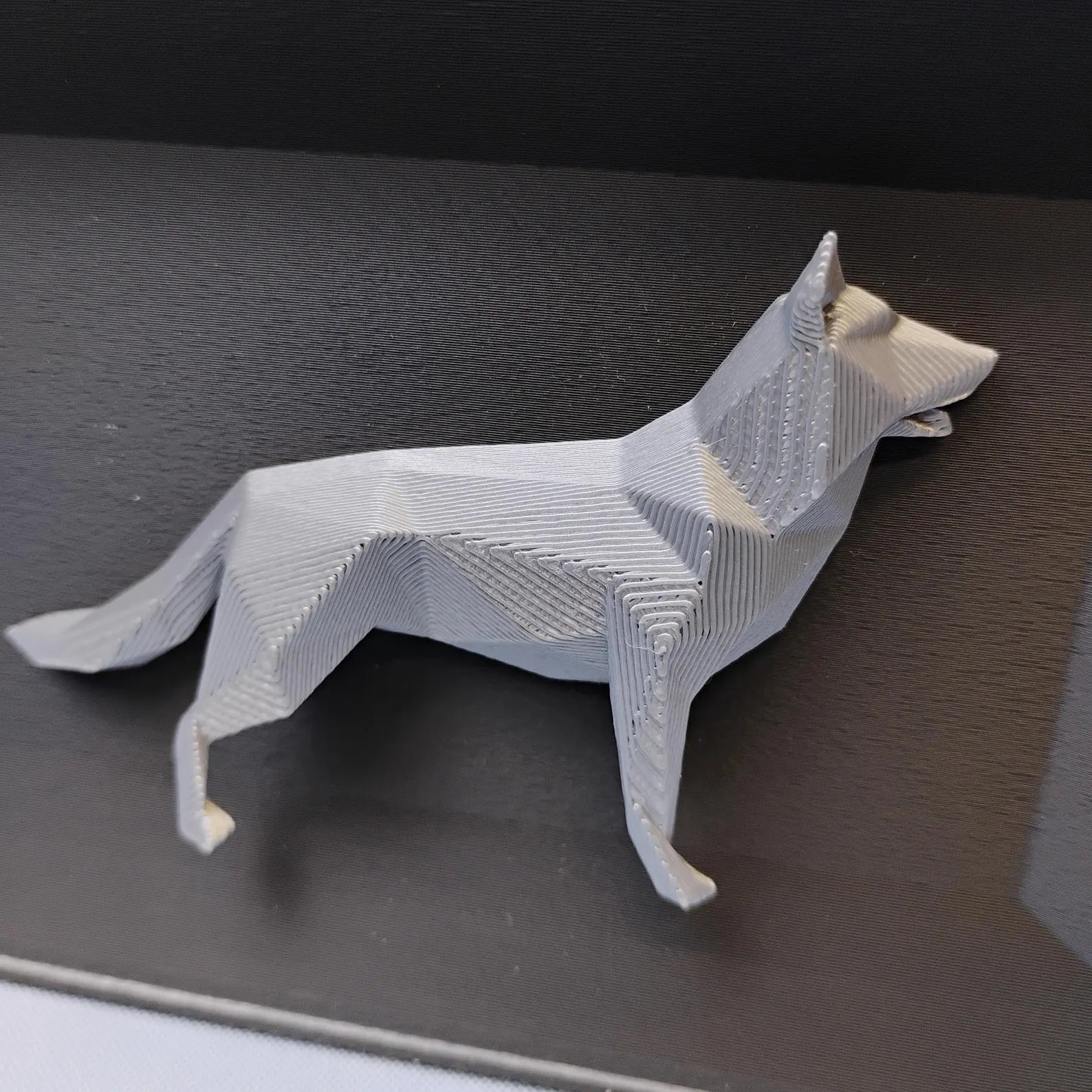 Close-up of raised geometric German Shepherd detail used on the front of the desk organizer