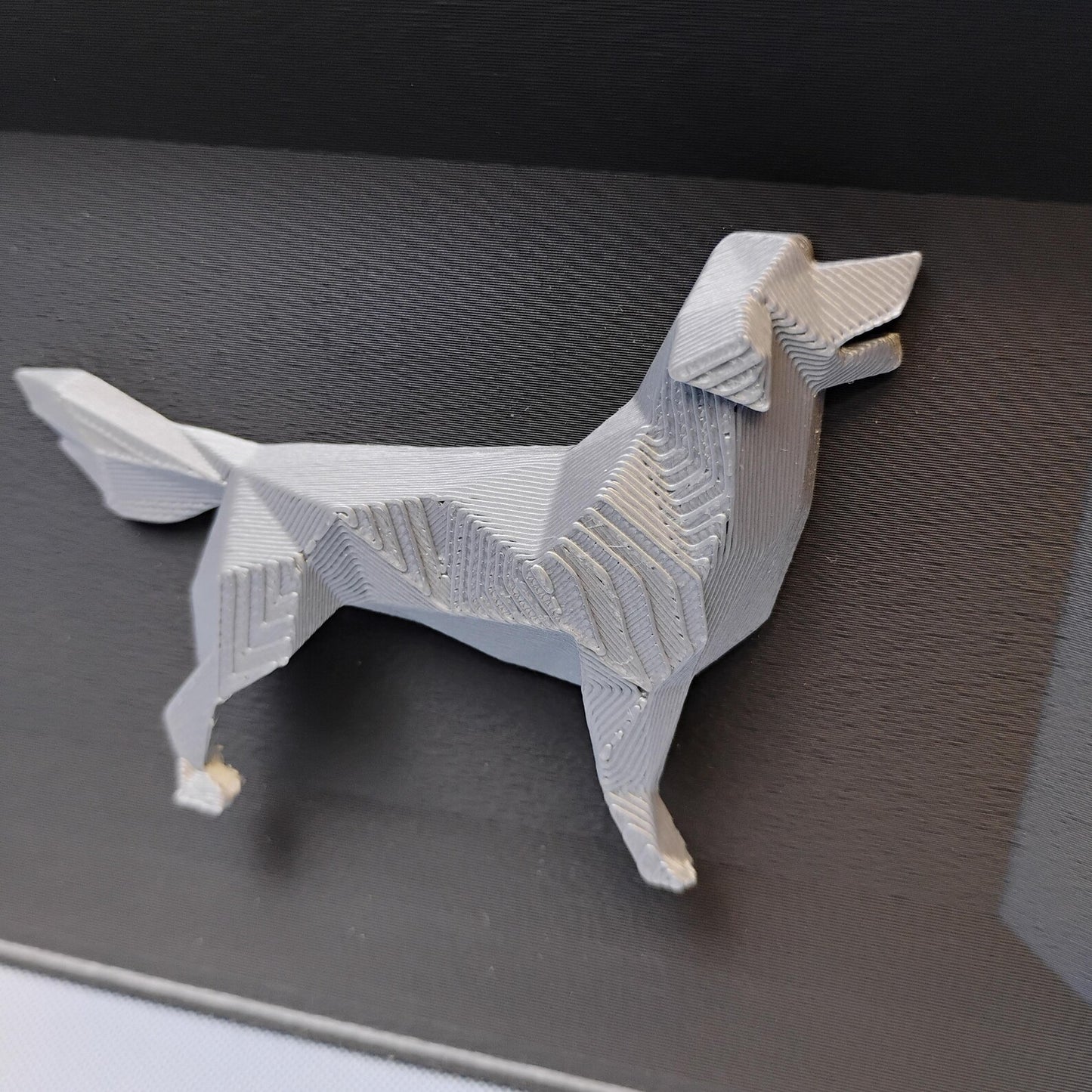 Close-up of raised geometric Golden Retriever detail used on the front of the desk organizer