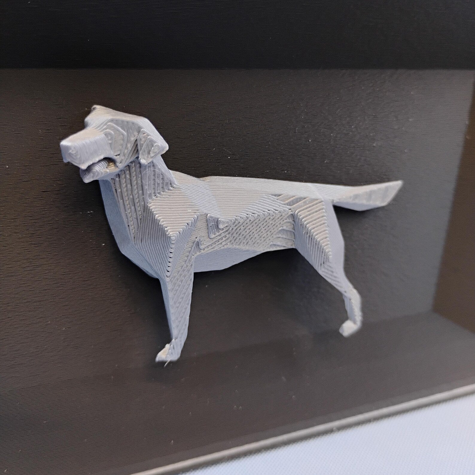 Close-up of raised geometric Labrador detail used on the front of the desk organizer