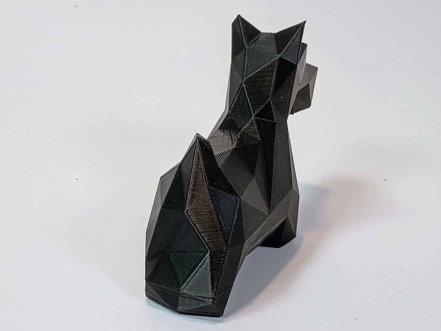 Low-poly Scottish Terrier figurine shown from a front angle with clean geometric lines