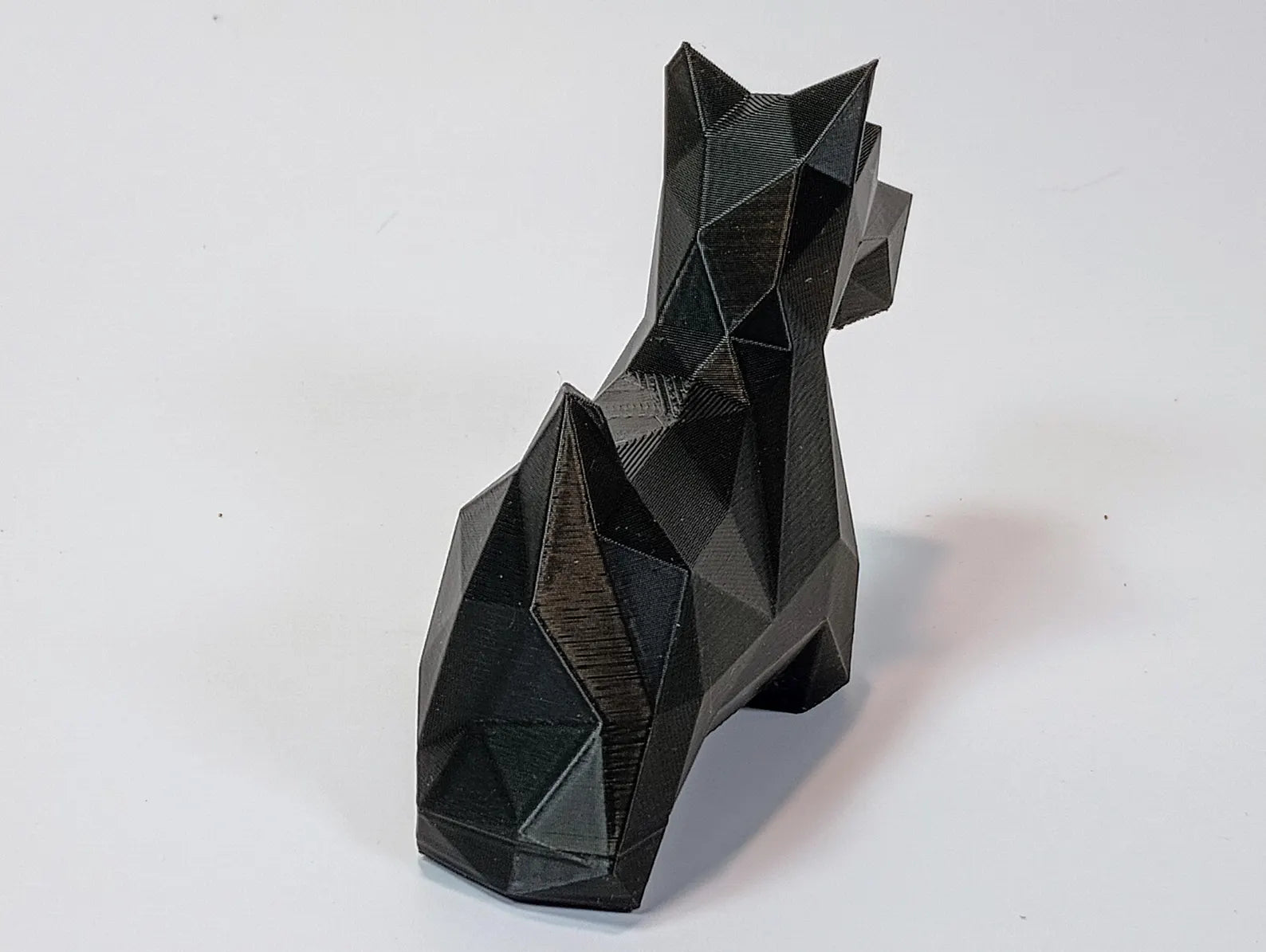 Low-poly Scottish Terrier figurine shown from a front angle with clean geometric lines