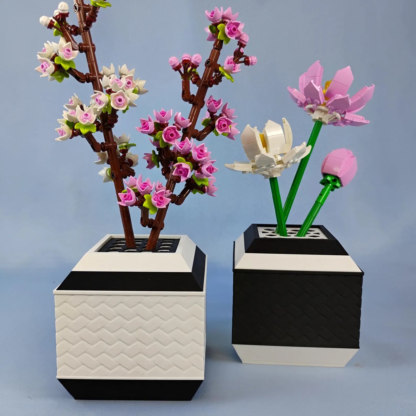 Black and white geometric vases holding LEGO® botanical flowers as modern decor