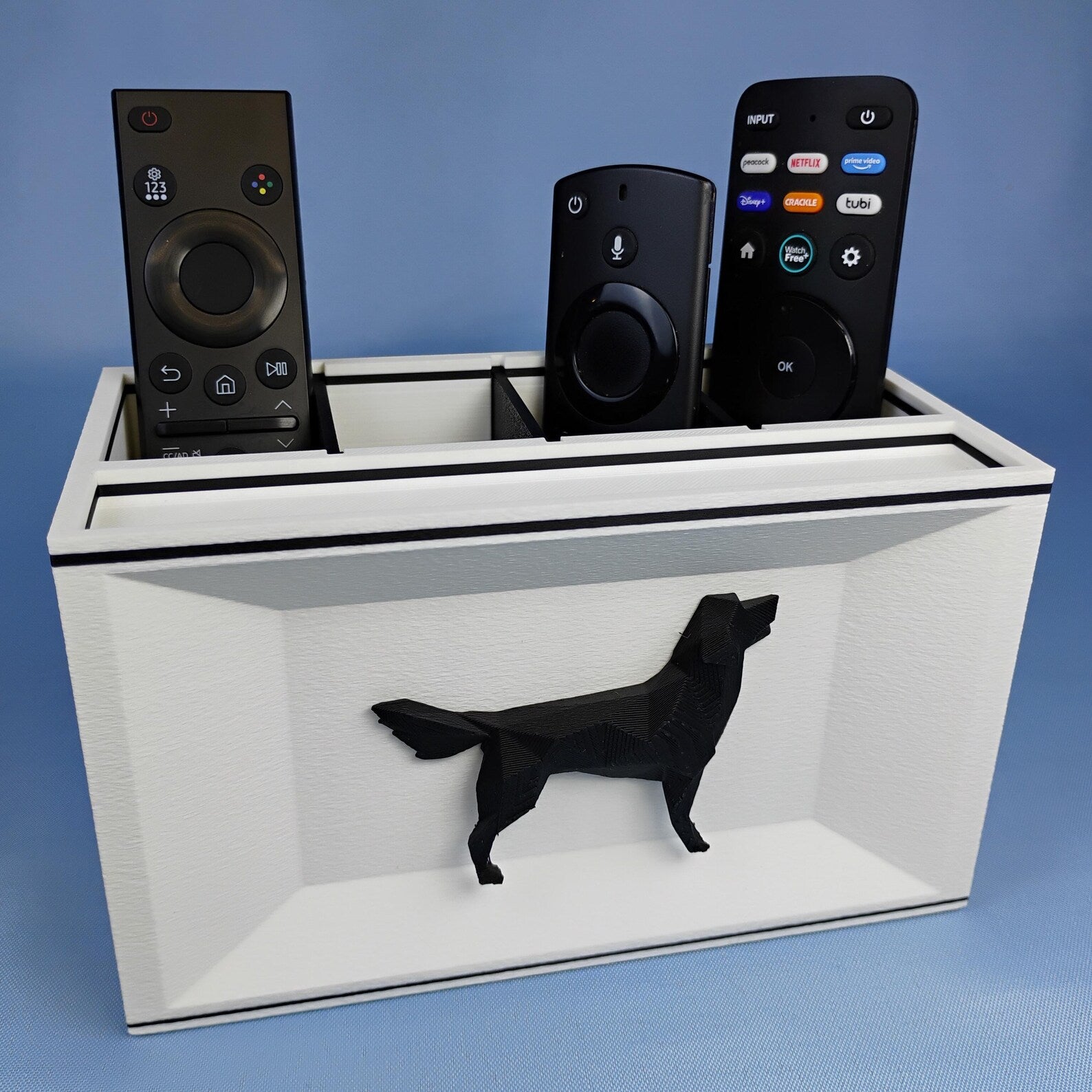 White Golden Retriever remote holder with black dog detail photographed on a blue background