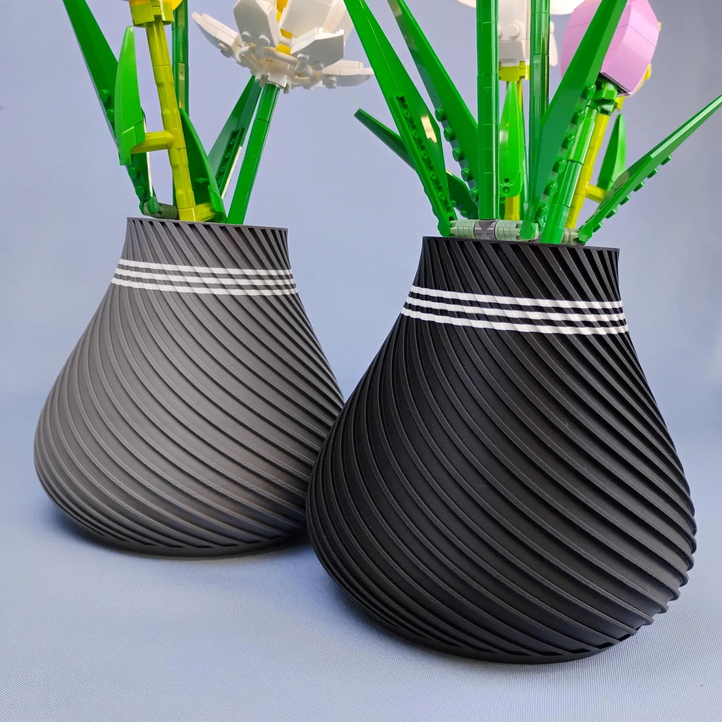Gray and black swirly vases shown together with modern spiral texture