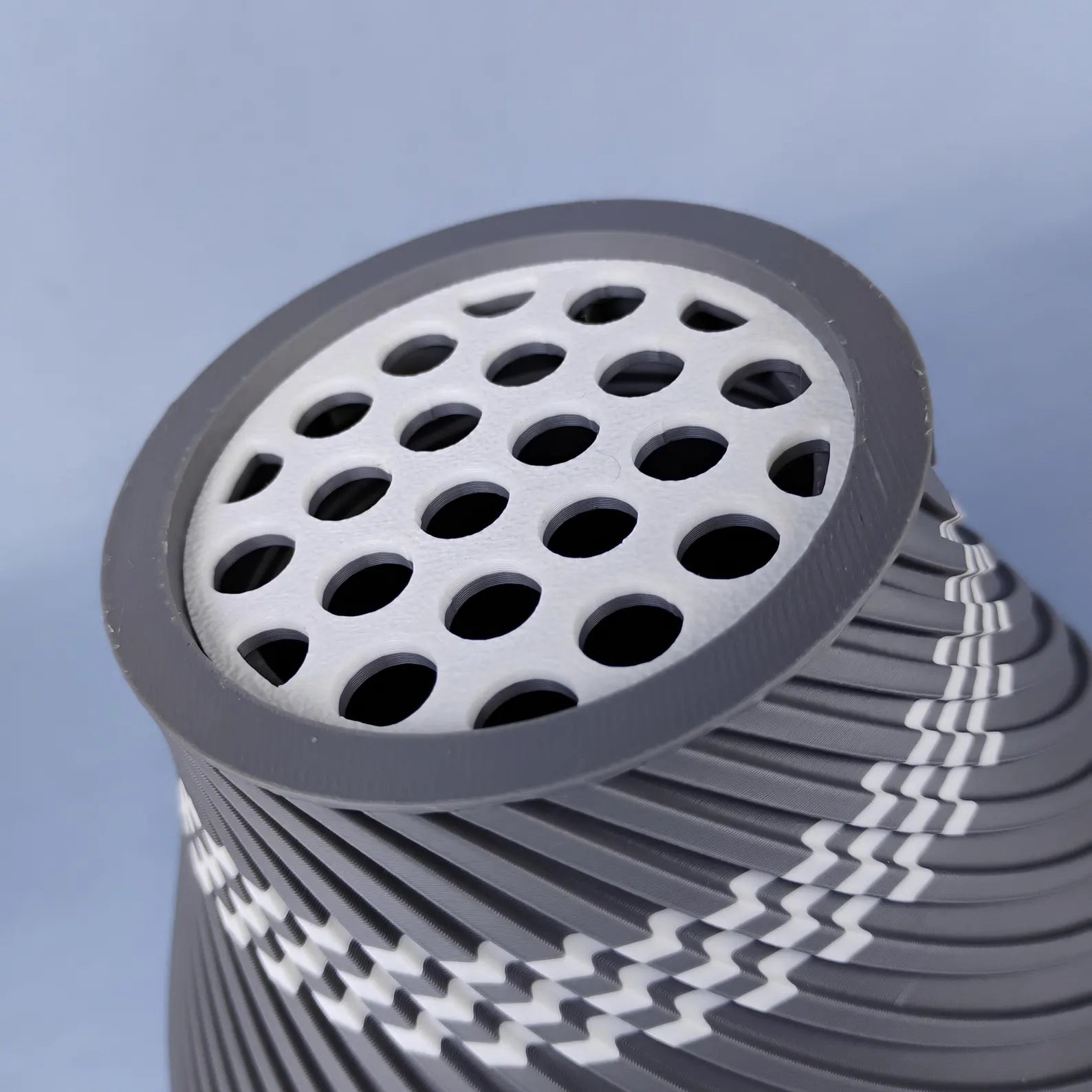 Close-up of gray swirly vase with top grid insert for arranging LEGO® flower stems