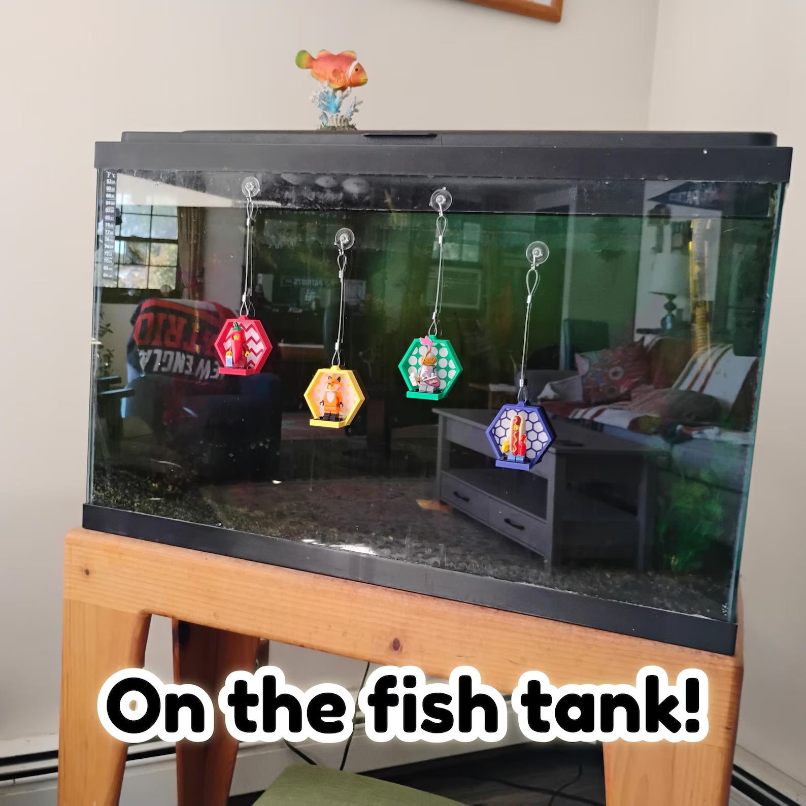 Hanging LEGO® minifigure displays attached to a fish tank using suction cups, showing another smooth surface display option.