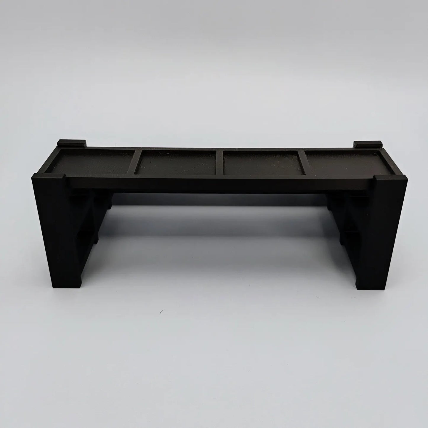 Smaller black display stand for LEGO® minifigures shown empty on a white background.