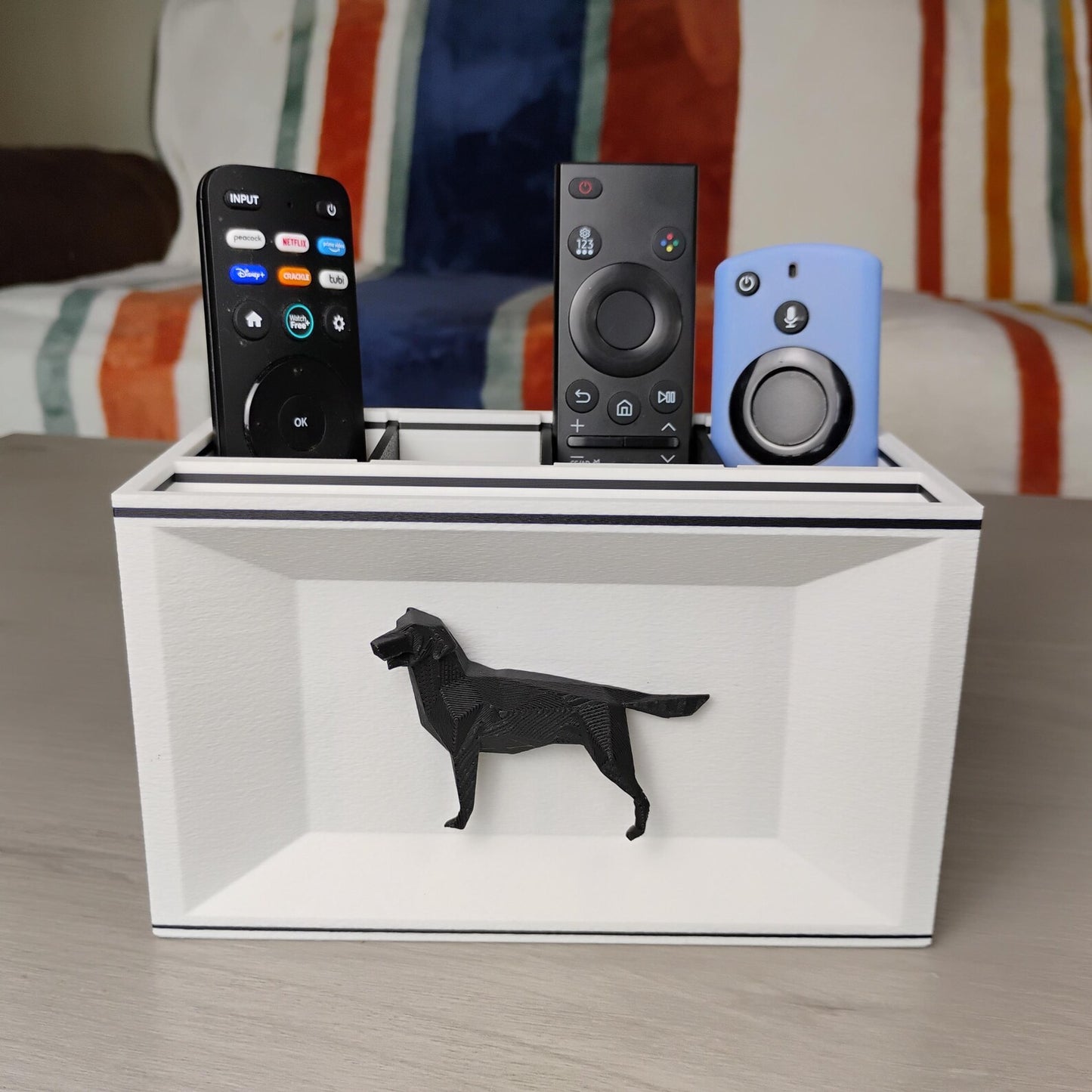 White Labrador desk organizer on a tabletop holding remotes and small electronics