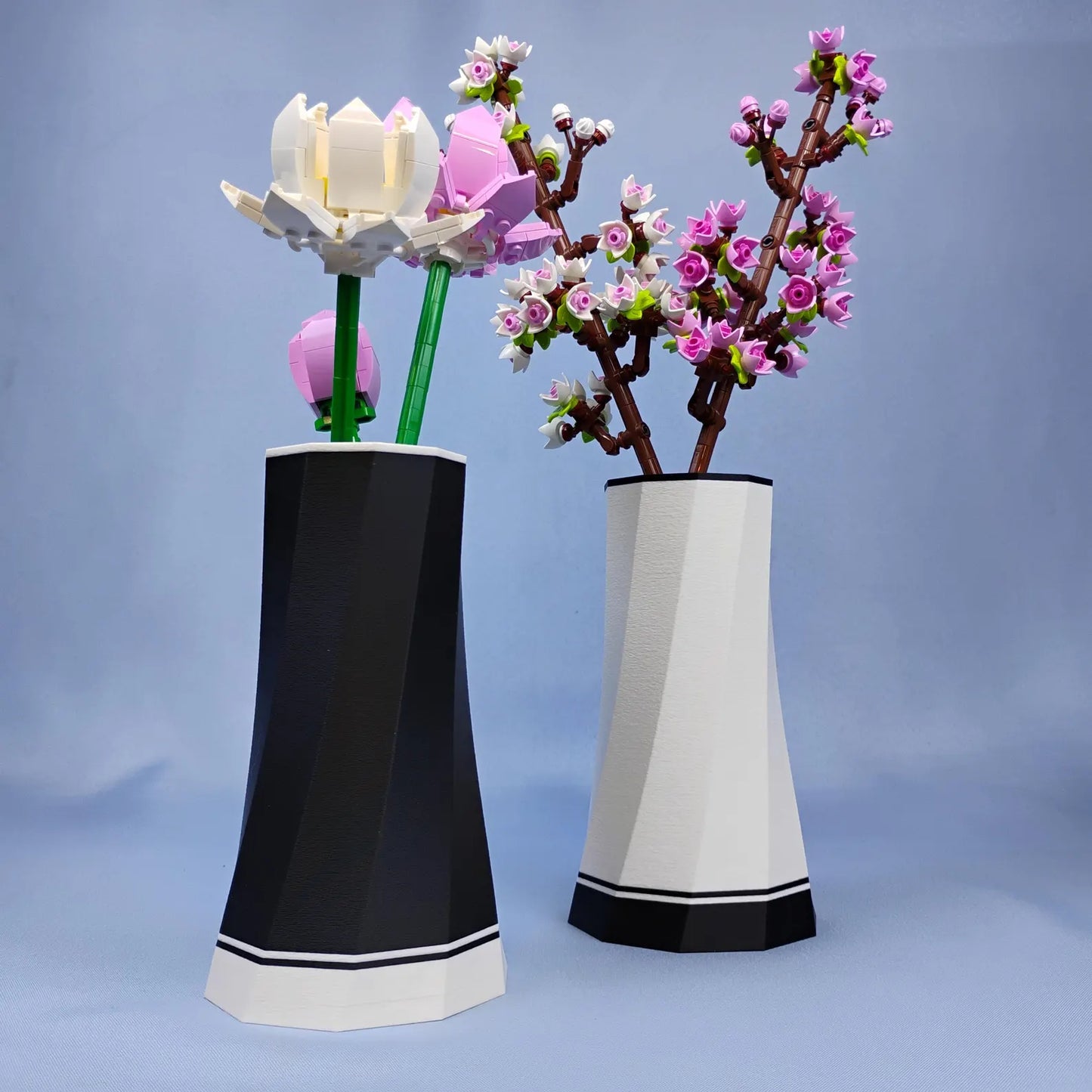 Black and white faceted vases displayed with LEGO® Botanical flower stems, showing two color options for desk and shelf decor.