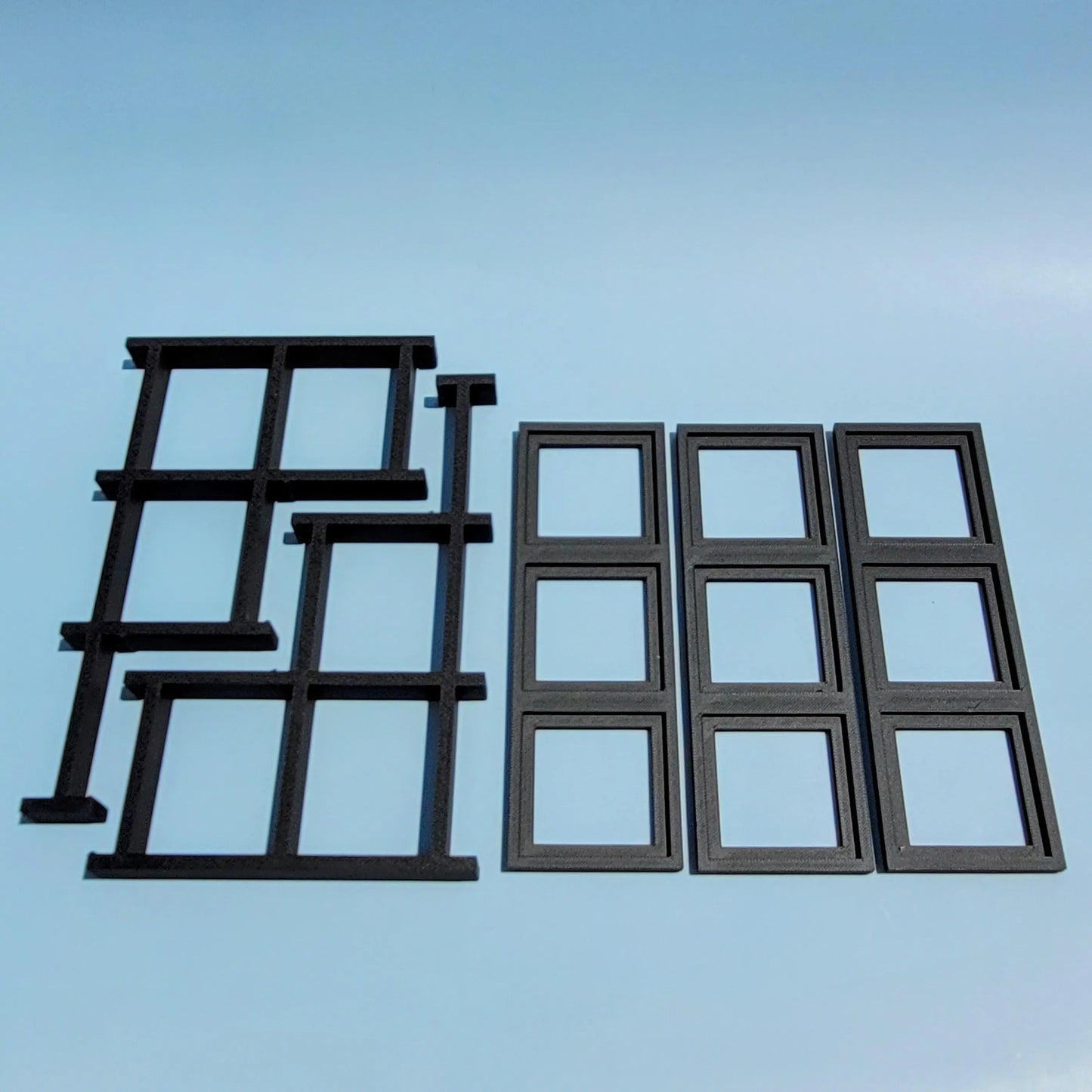 Disassembled display stand for LEGO Brickheadz figures. Blue background