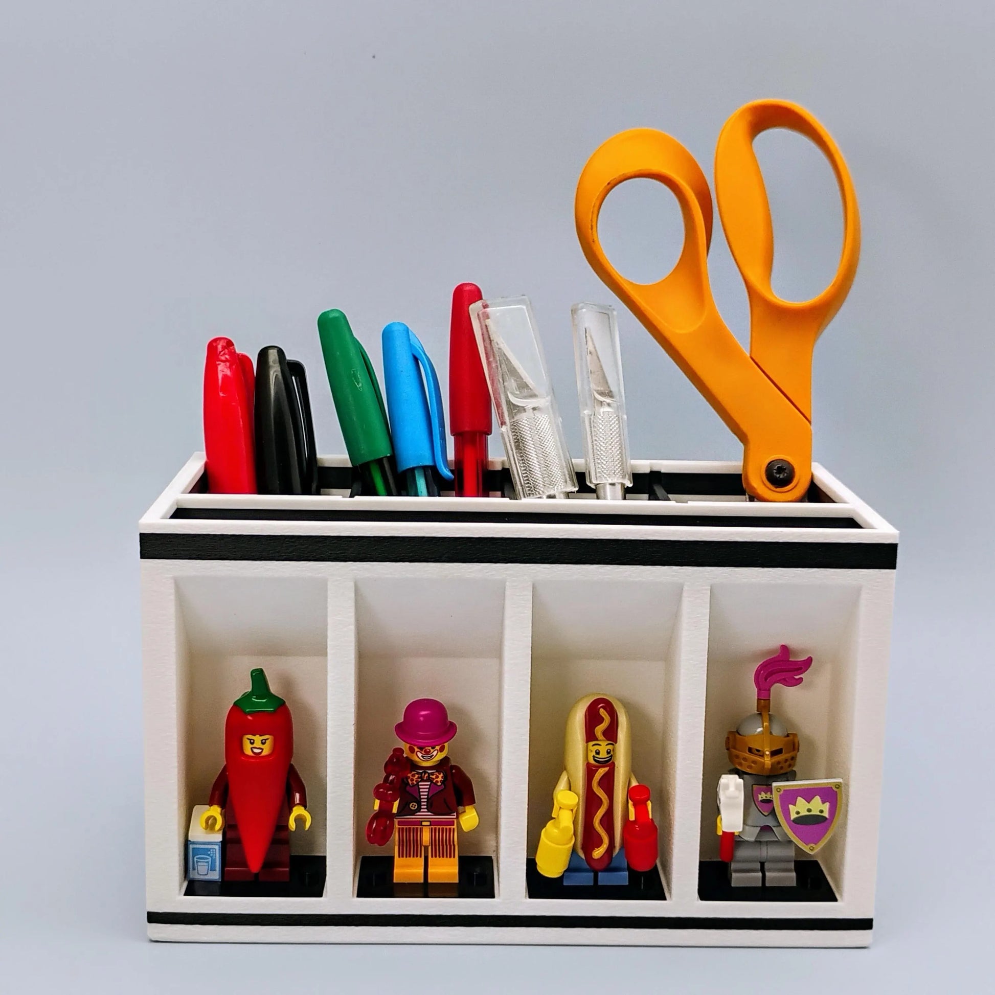 Desk organizer with colorful markers, scissors, and LEGO Minifigures being displayed.
