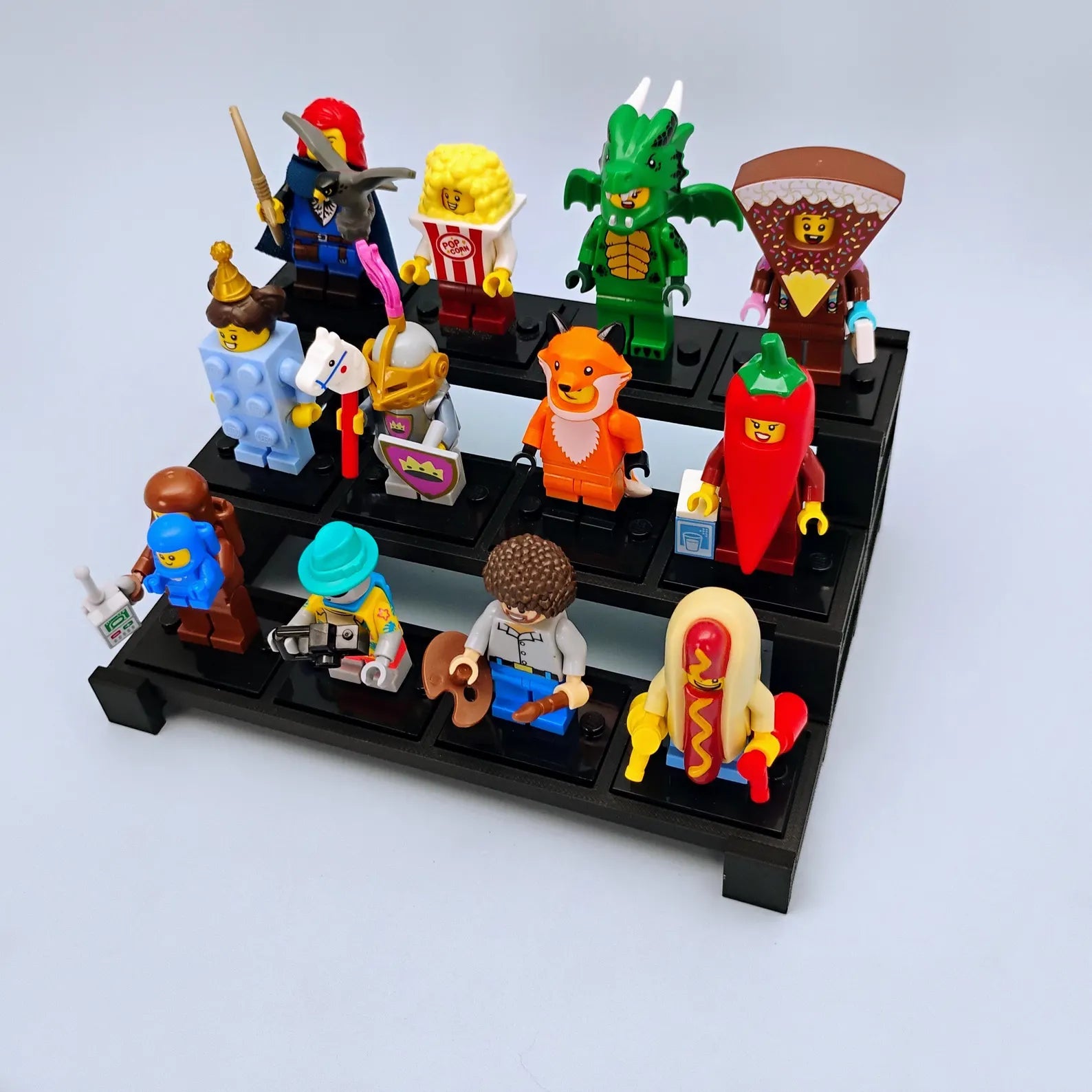Tiered display stand filled with LEGO® minifigures, showing how a collection can be organized across multiple rows.