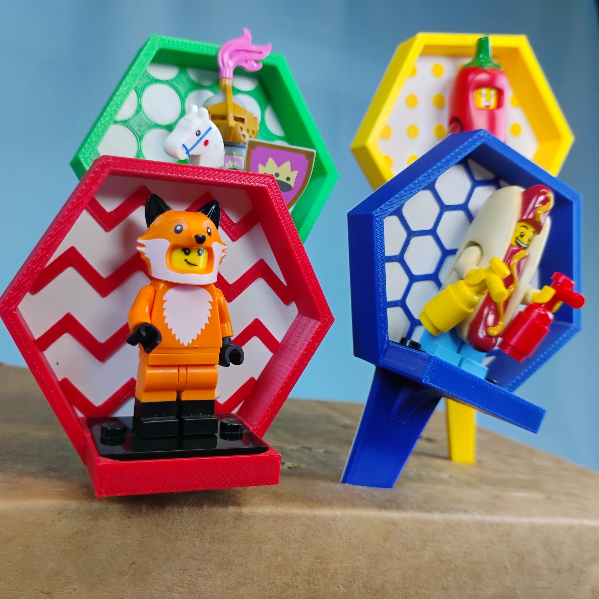 Colorful LEGO® minifigure plant stake displays with assorted minifigures shown together on red, green, yellow and blue stands.