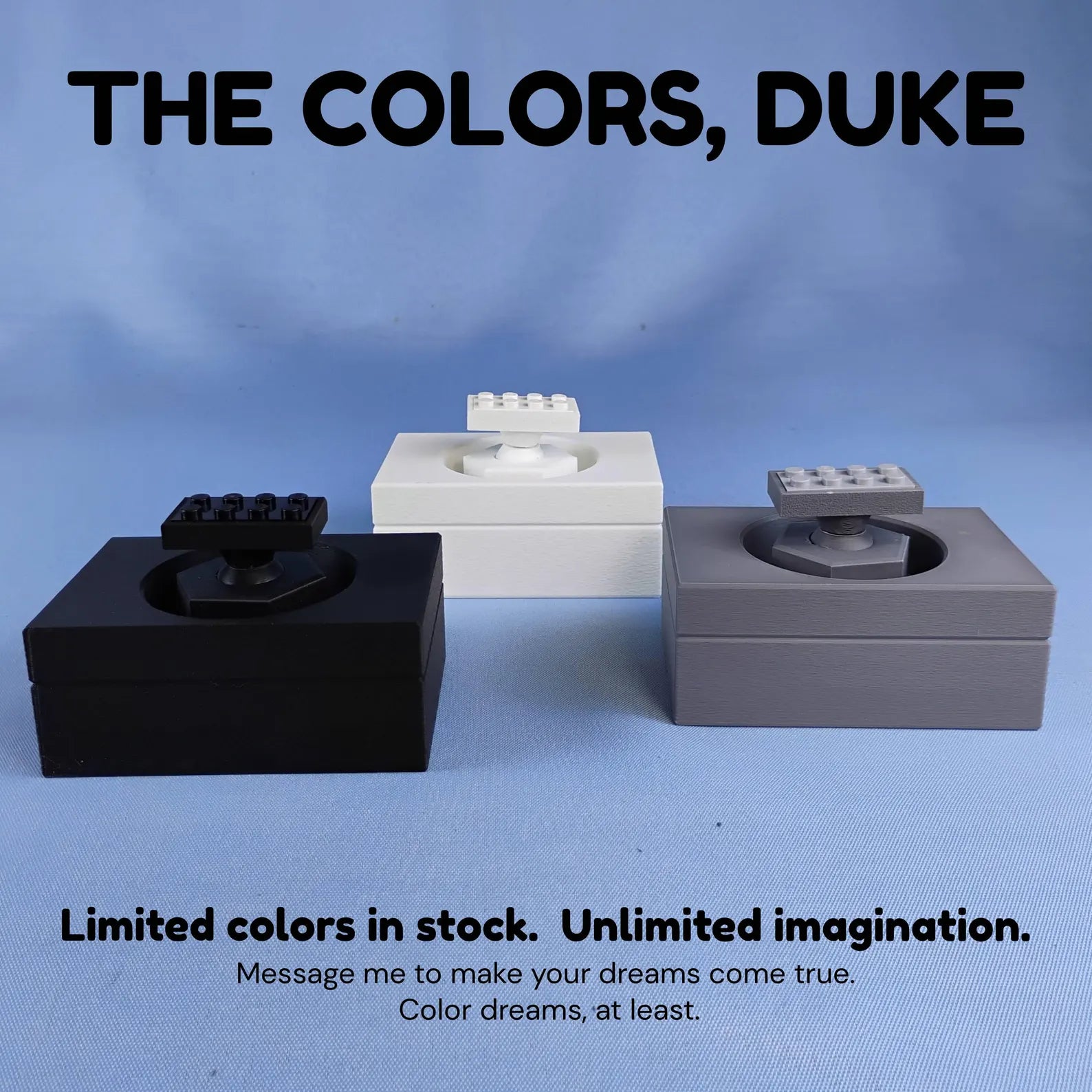 Color options for adjustable desk display stand for LEGO® ships, shown in black, white, and gray.